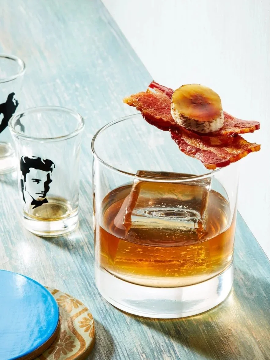Bourbon shot with cooked bacon and banana as garnish - Elvis theme - shot for whisky advocate magazine, photographed by Jeff Harris - food styling, commercial food stylist NYC