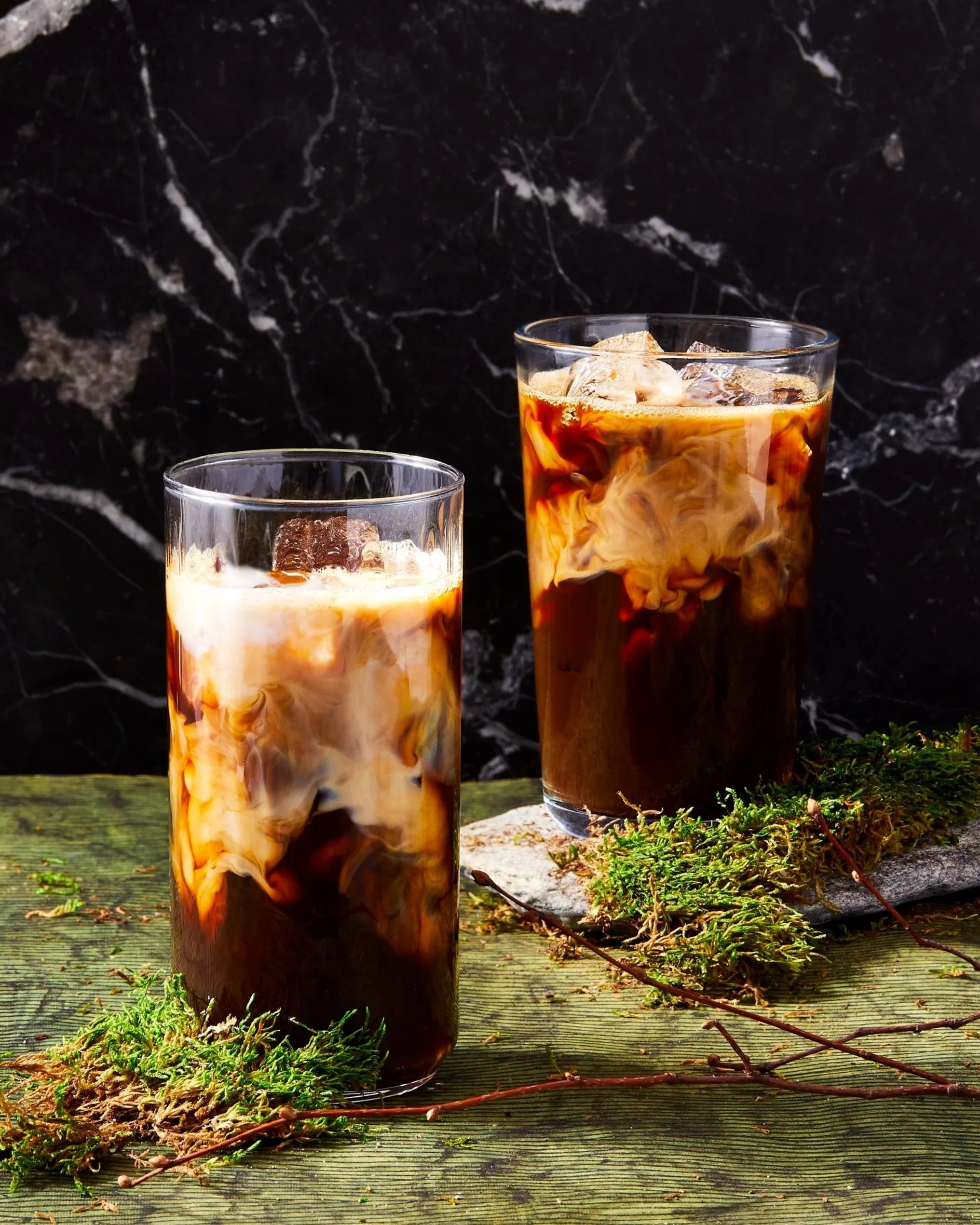 Two iced coffees with iced coffee swirls, photographed by Rachel Vanni - food styling, commercial food stylist NYC