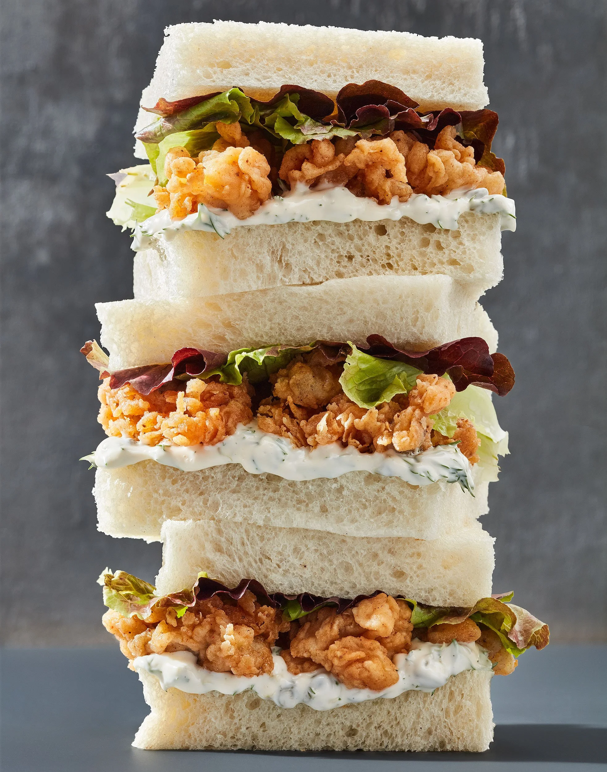 PA stack of sandwiches filled with deep fried clams, tartar sauce and lettuce - photographed by Yunhee Kim for a test concept shoot - food styling, commercial food stylist NYC