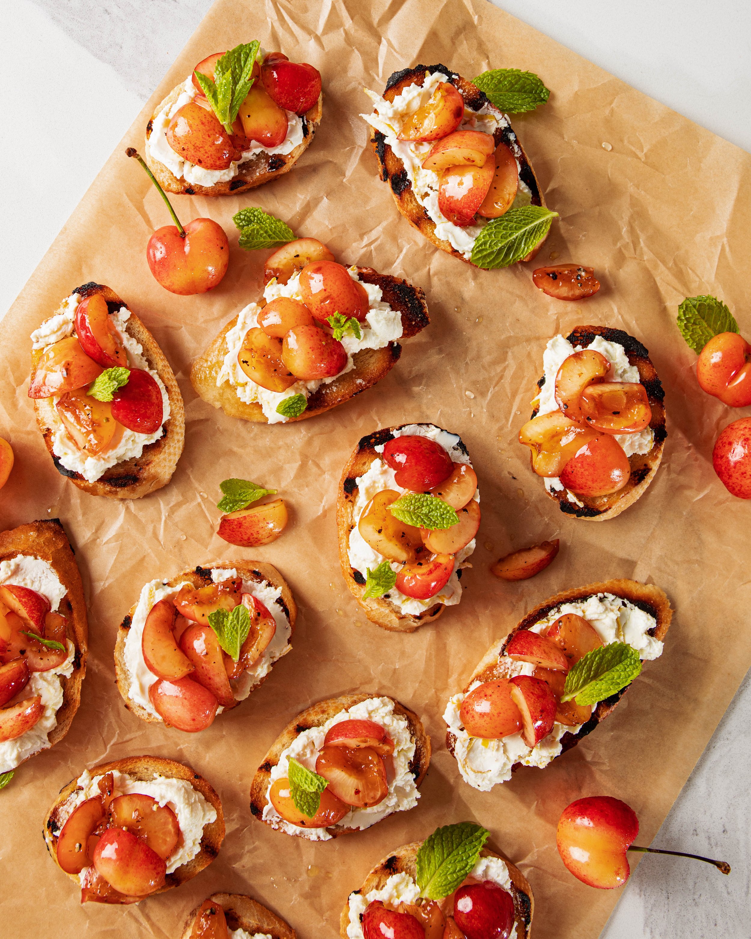 Sweet rainer cherries on whipped ricotta crostini, photographed by Sarah Rocco - food styling, commercial food stylist NYC