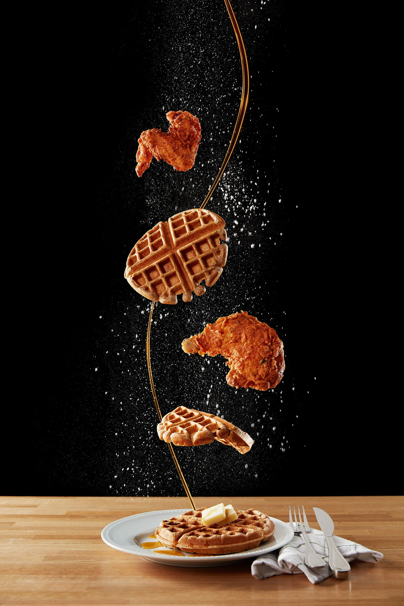 Falling food - frozen in tims of fried chicken and waffles with maple syrup - shot for a concept shoot, photographed by Cheng Li -  food styling, commercial food stylist NYC
