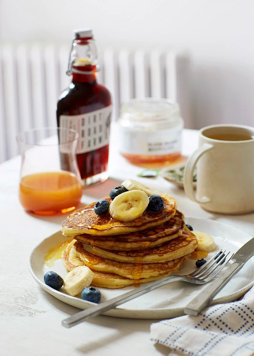 Stack of pancakes with blueberry and bananas and maple syrup, photographed by Dane Tashima - food styling, commercial food stylist NYC