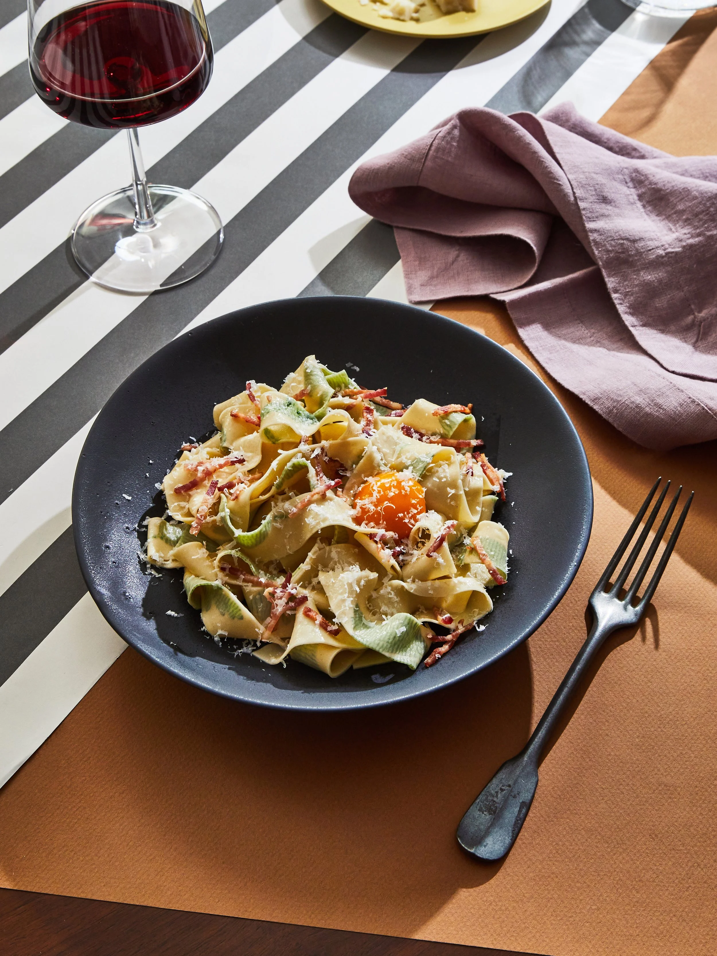 Handmade pasta with herbs pressed inside, carbonara sauce with bacon, parmesan cheese and an egg yolk - for a test concept shoot - food styling, commercial food stylist NYC