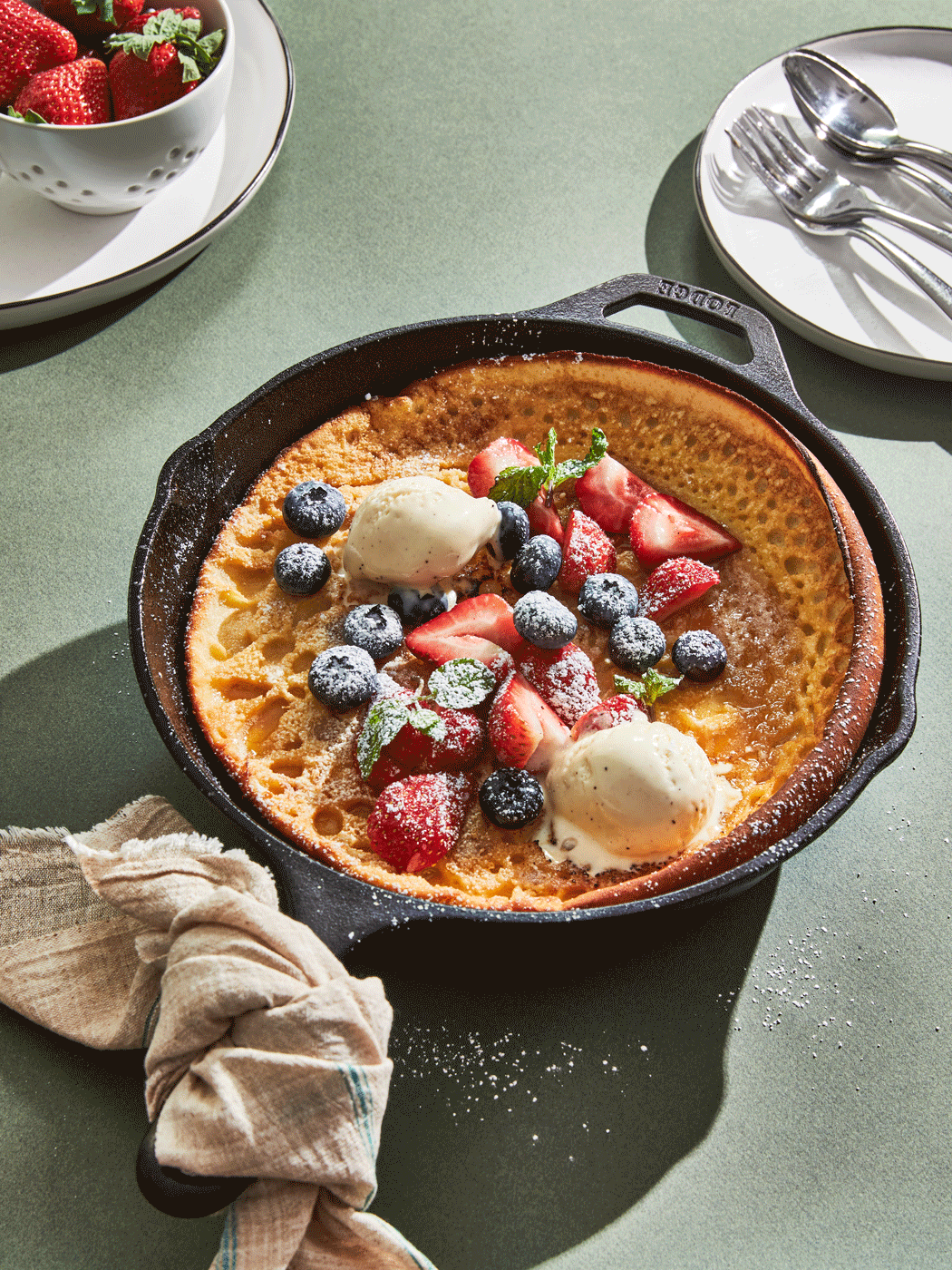 Skillet baked Dutch Baby pancake with strawberry, blueberry and ice cream - shot in stop motion - food styling, commercial food stylist NYC