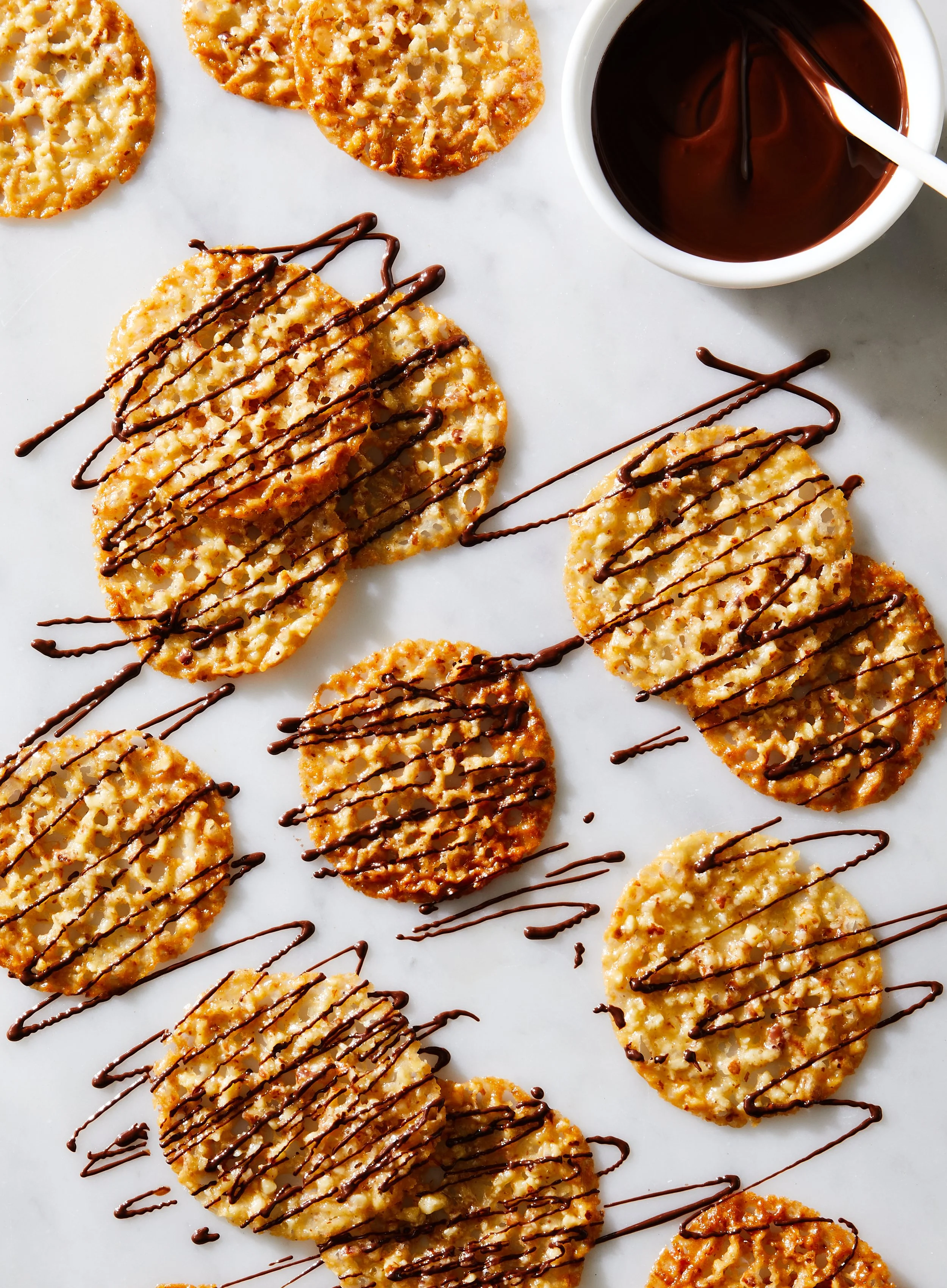 almond lace cookings stacked with chocolate drizzle on top - shot for Delicious Magazine photographed by Rachel Vanni - food styling, commercial food stylist NYC