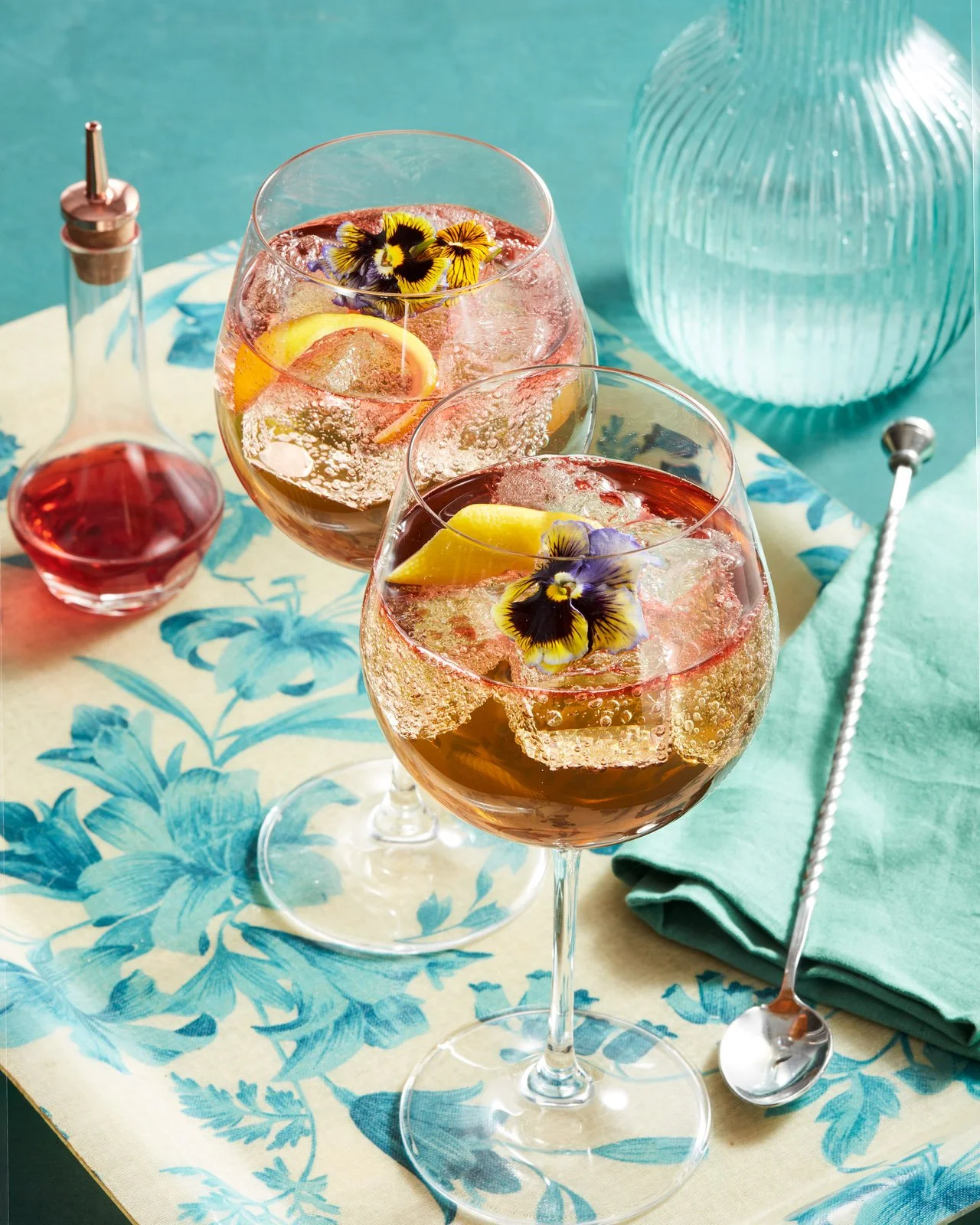 Two cocktail spritz with flowers as garnish - shot for whisky advocate magazine, photographed by Jeff Harris - food styling, commercial food stylist NYC
