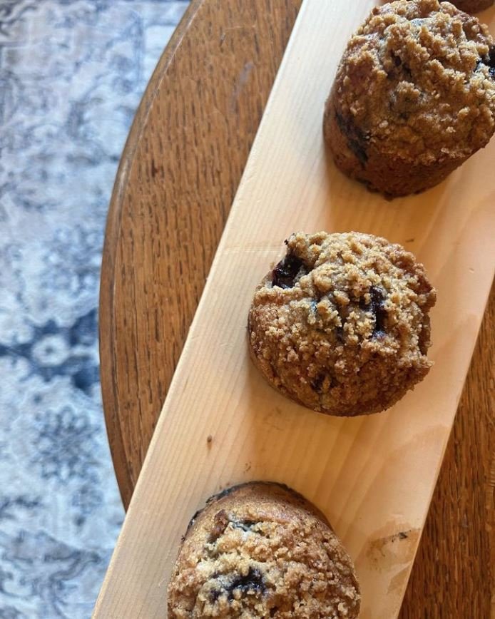 The tender crumb of a perfect morning cake and fresh blueberries, topped with a brown sugar streusel and drizzled with a spiced vanilla glaze. The blueberry muffin at The Bakert at 1871.
