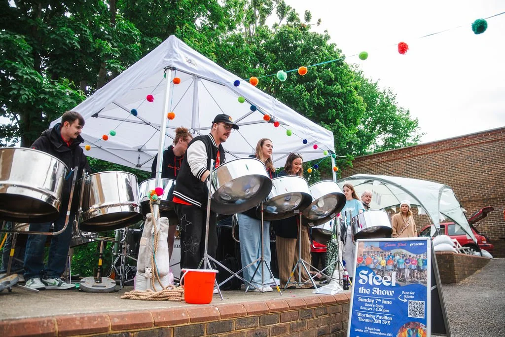 The Sussex Steel Band performing under a gazebo at the makers fair
