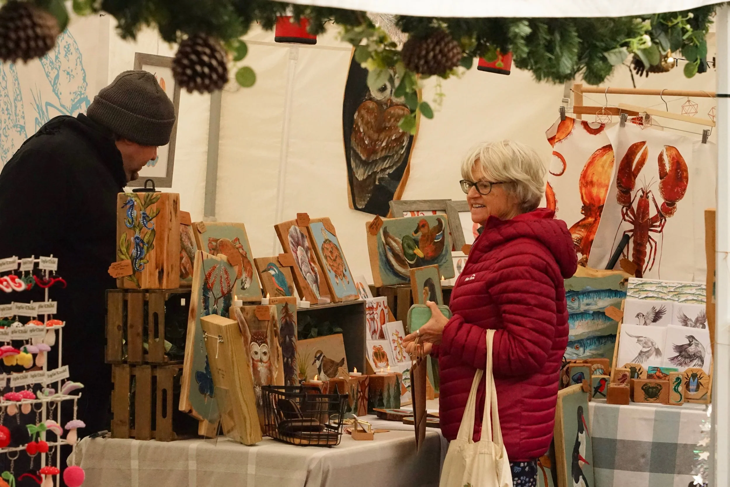 A customer outside looking at a wooden art display