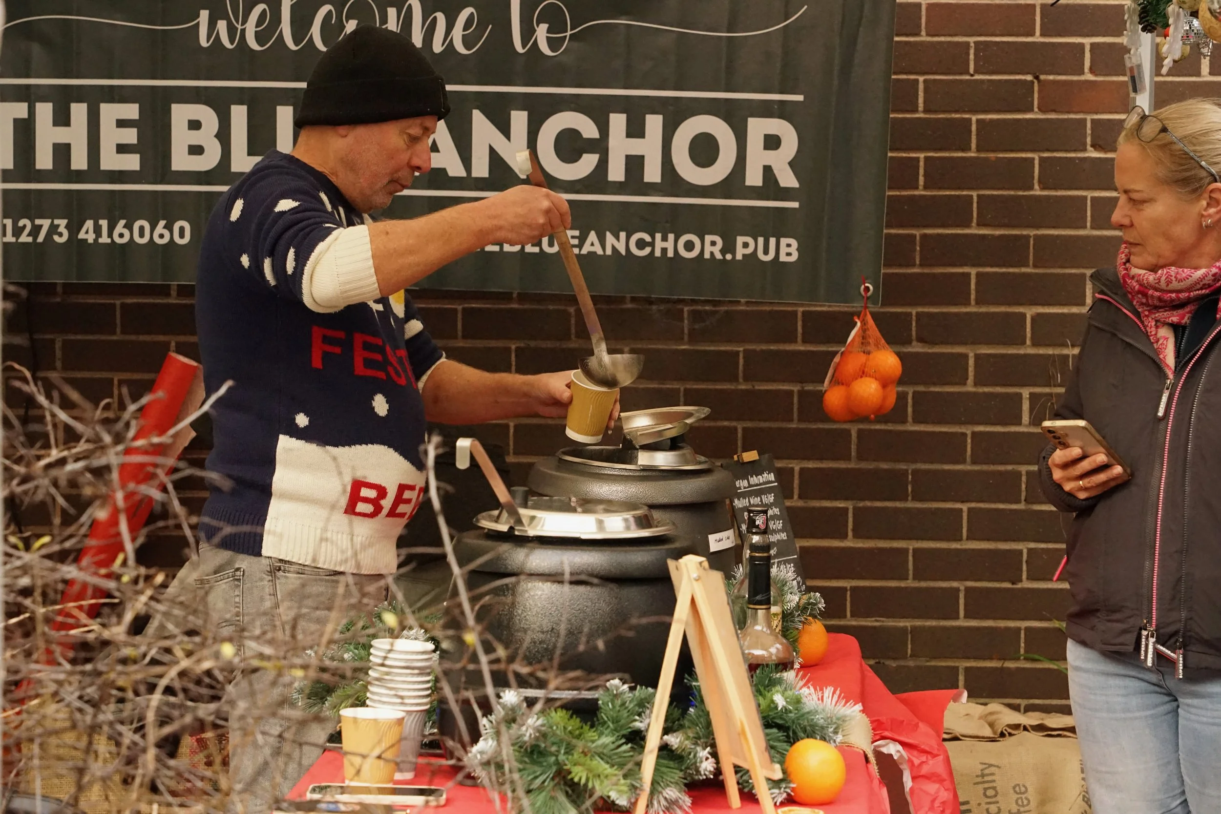 The pop-up bar pouring a mulled wine in the fig tree garden