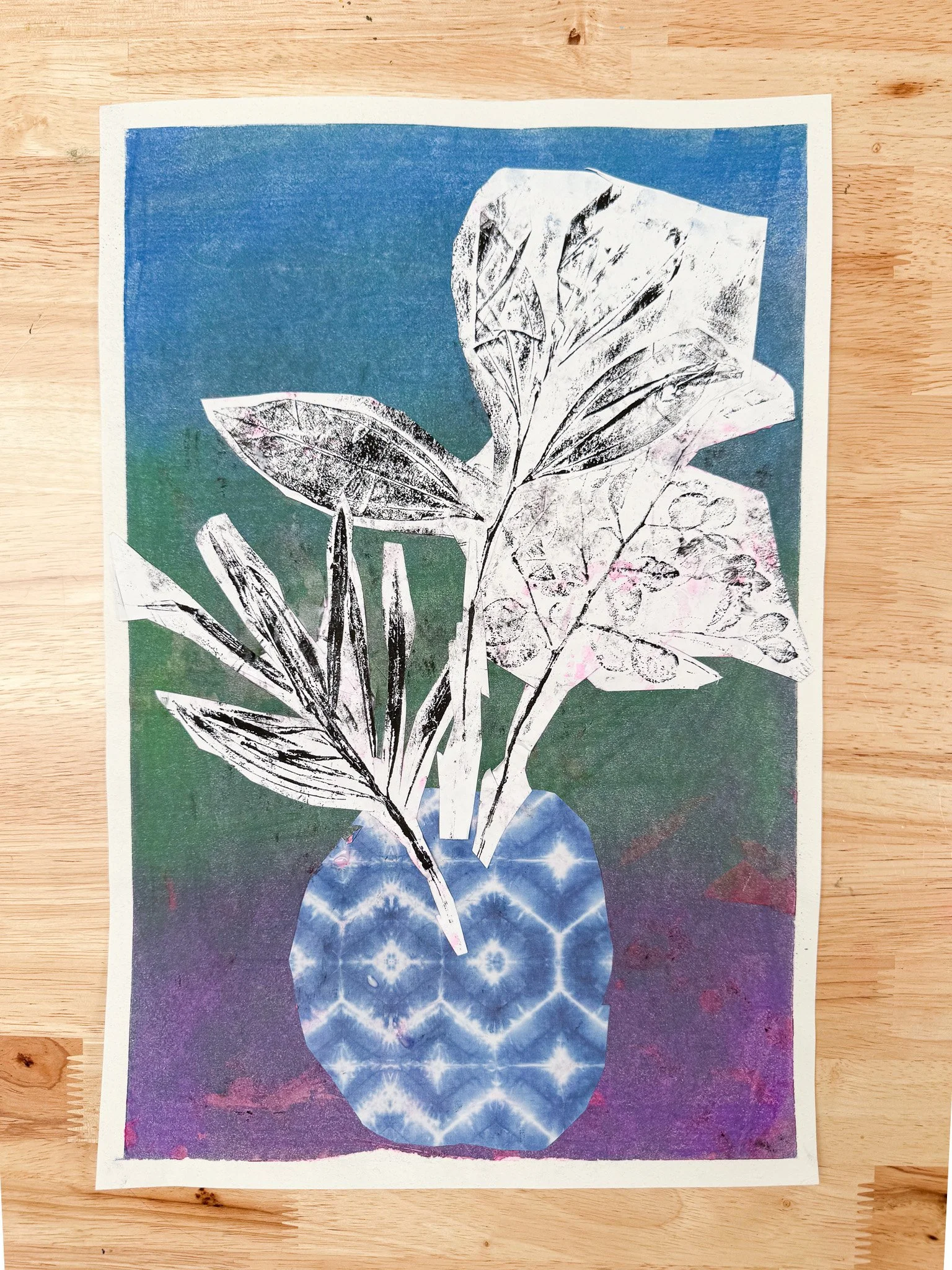 Collage art of a potted plant with layered leaves, set against a colorful, textured background.