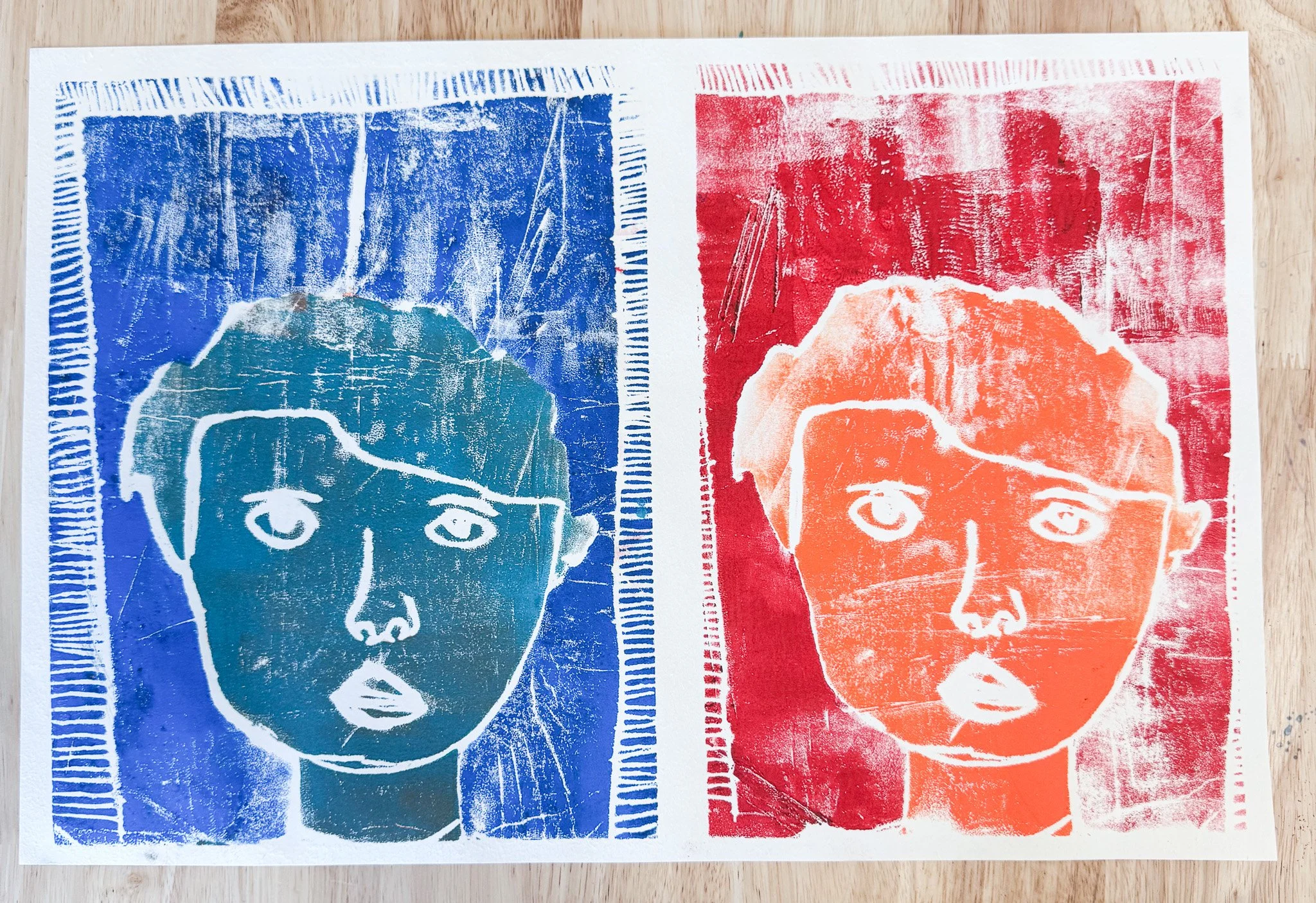 Screen print of two children's faces, one in blue on the left and one in orange on the right, in a pop art style.