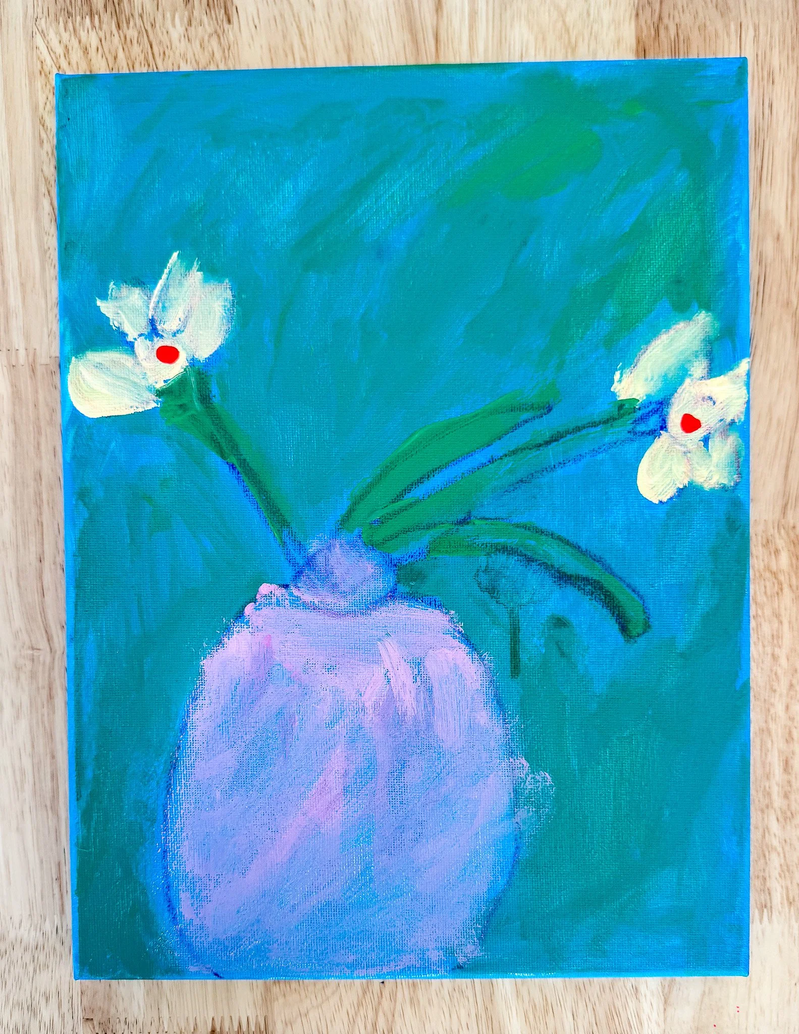 A painting of a still life with a light purple vase with two white flowers having red centers, surrounded by green leaves, all set against a blue and green background.