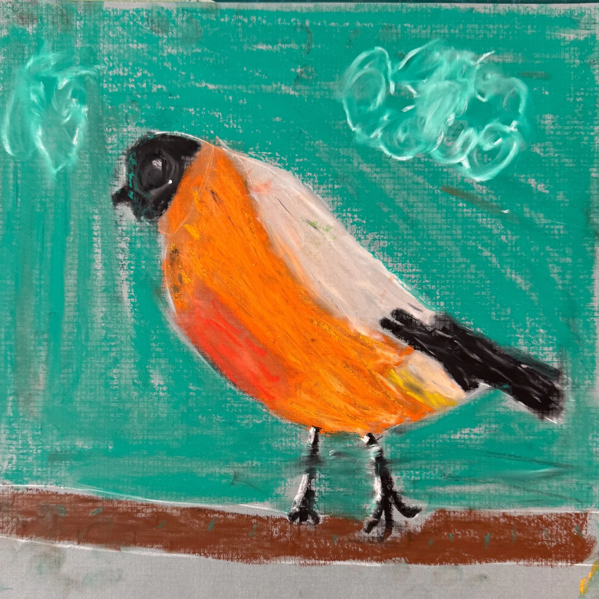 Children's drawing of a bird with an orange body, black head and tail, set against a teal background with a cloud.