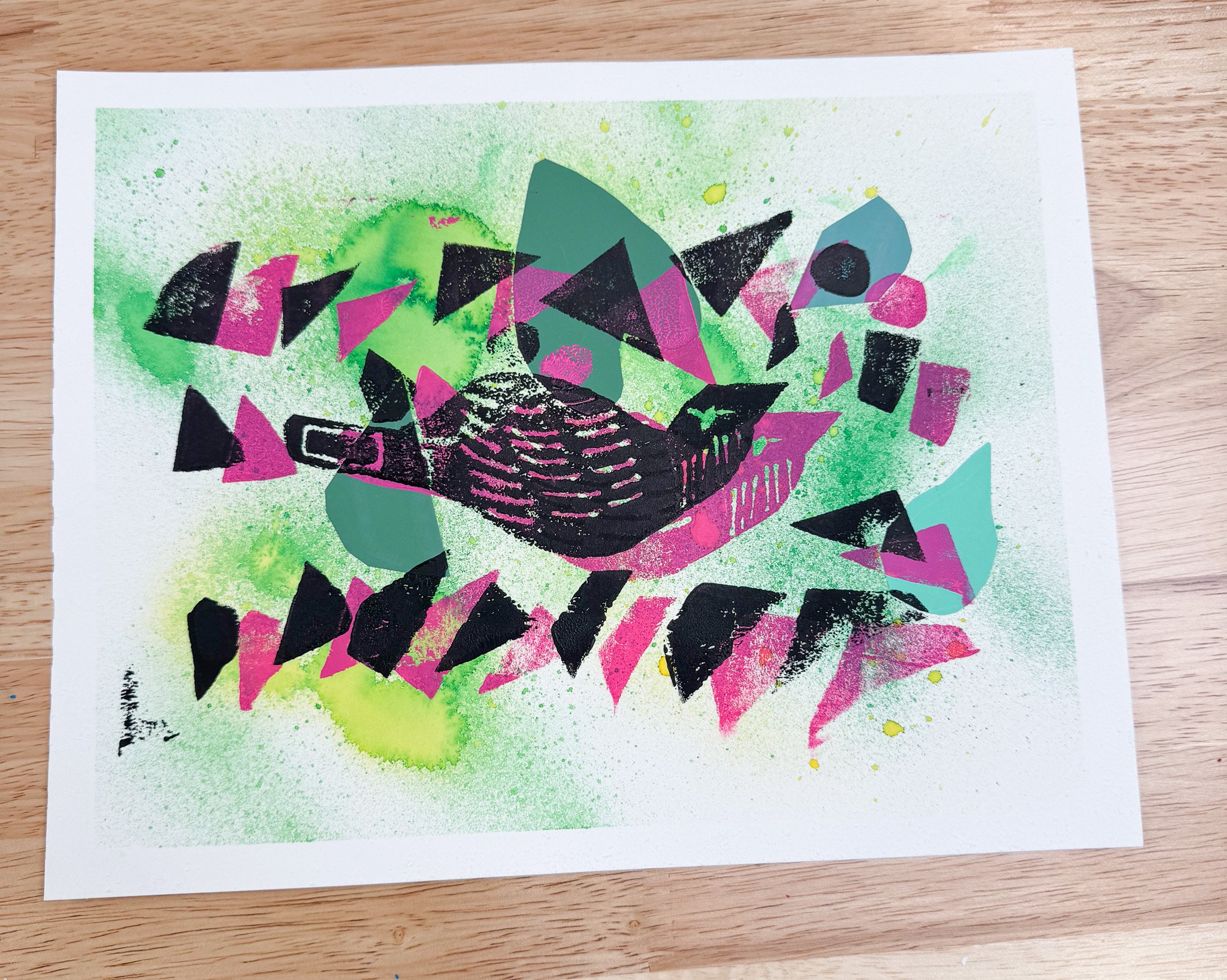 Abstract mixed media artwork with black, pink, and teal geometric shapes on a splattered green background.