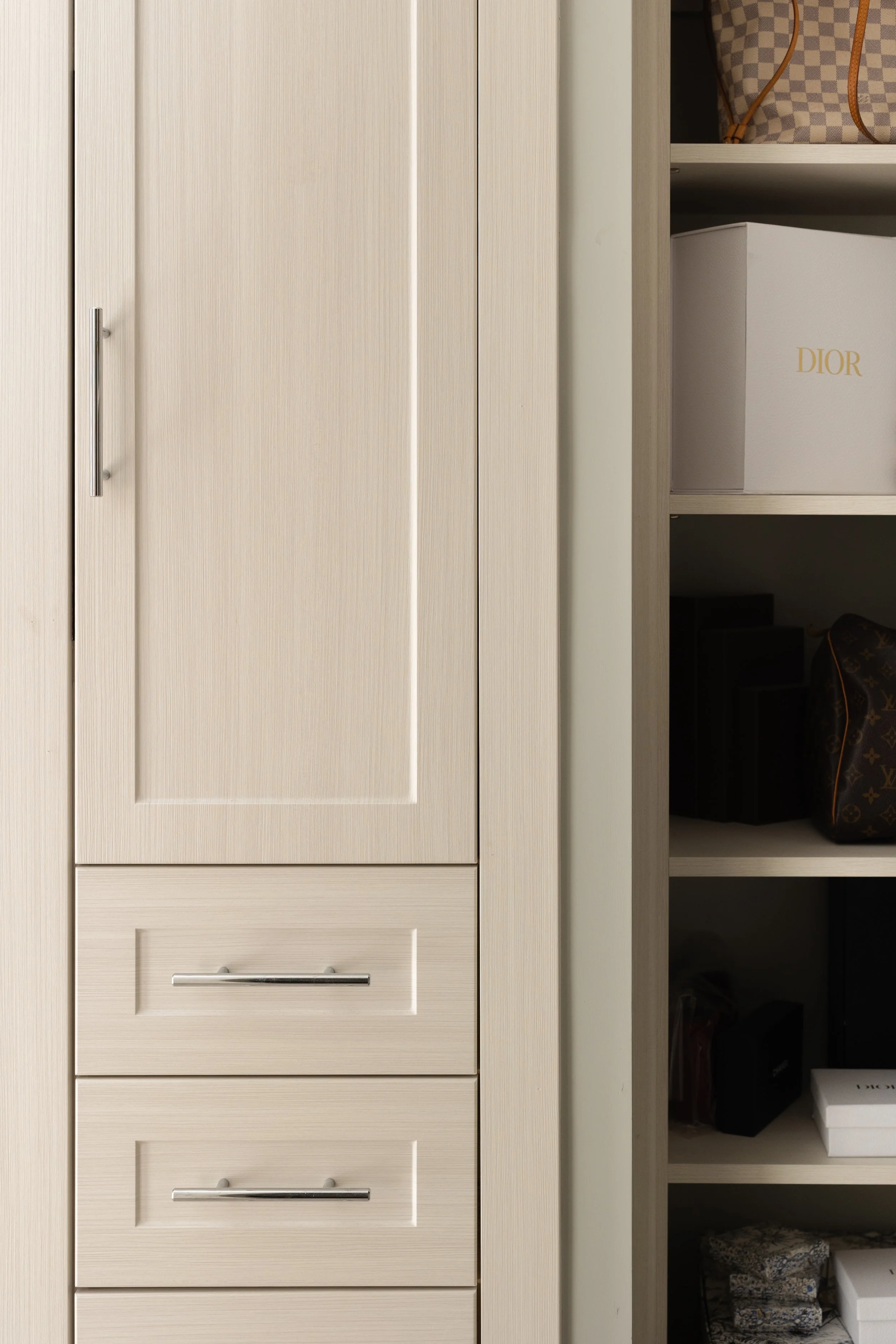 Beige wardrobe with drawers and adjacent shelves showing bags and a box labeled 'Dior'.