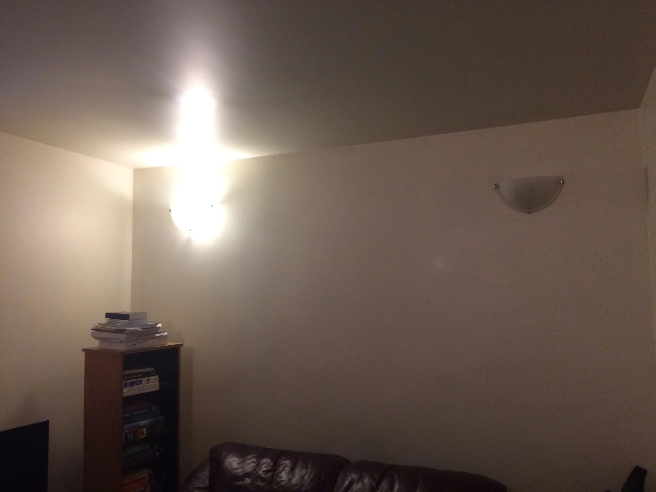 Basement unit with a too-low ceiling, no natural light, and only lighting at eye level