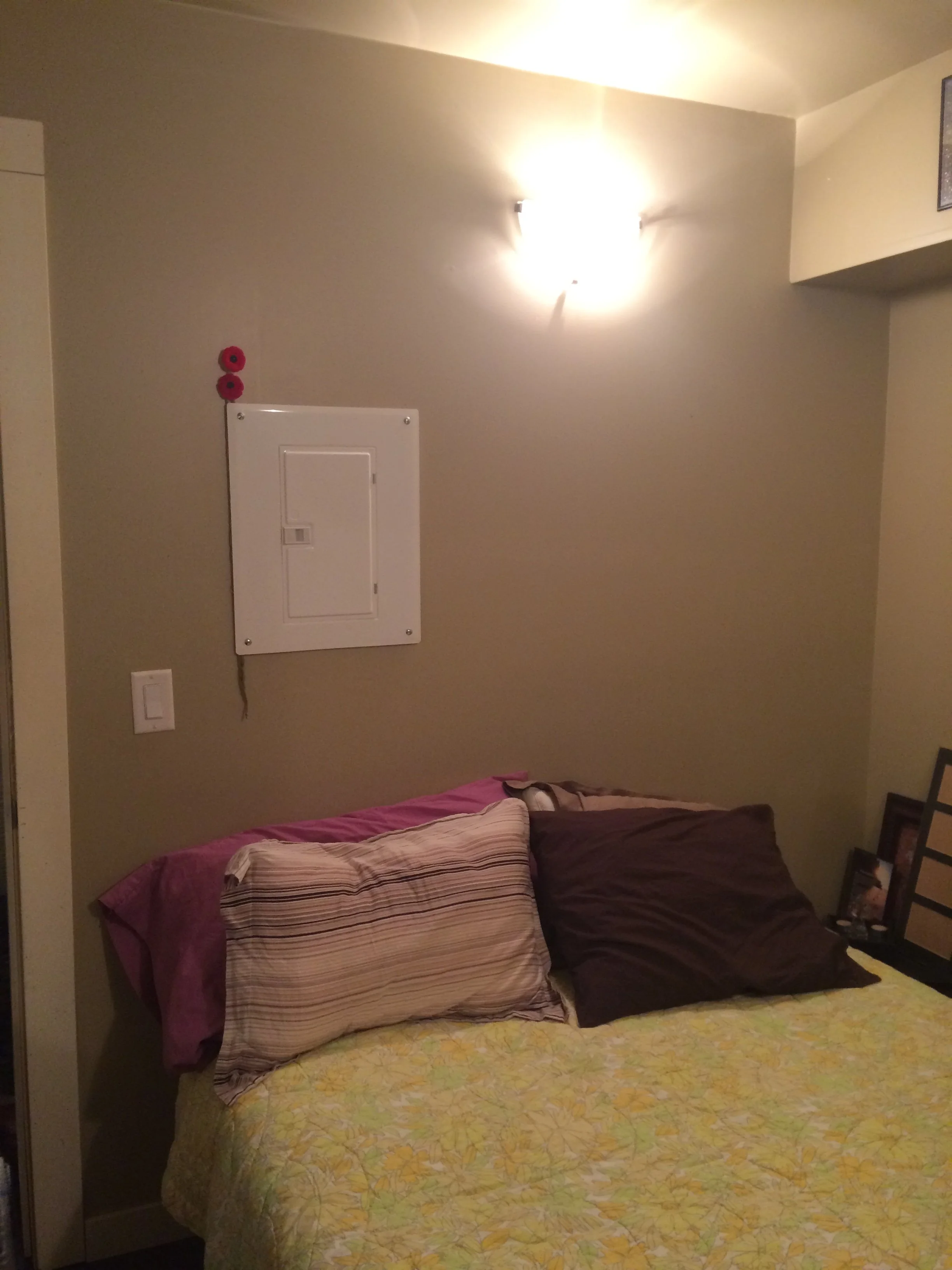 Bedroom with an electric box above the bed head