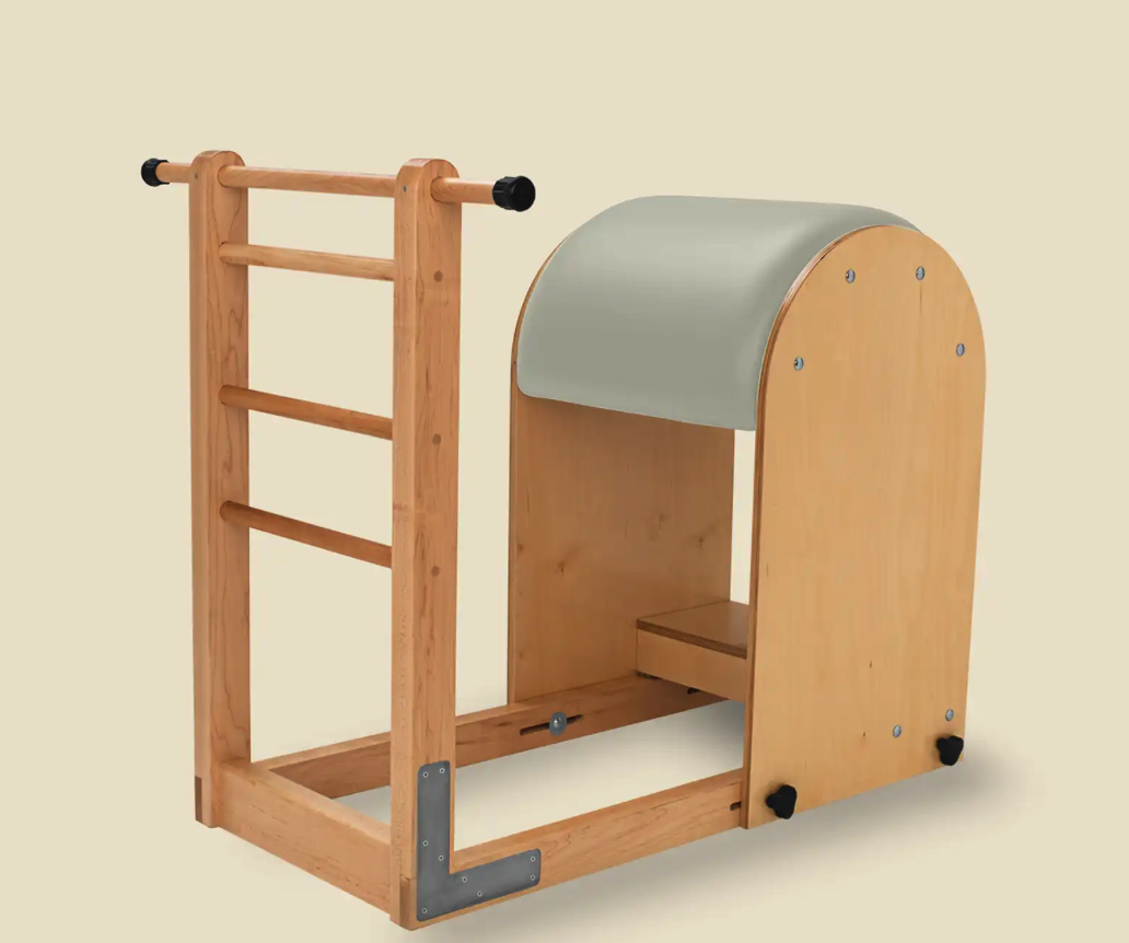 Image of a Classical Pilates Ladder Barrel with a wood frame and a sage green upholstery