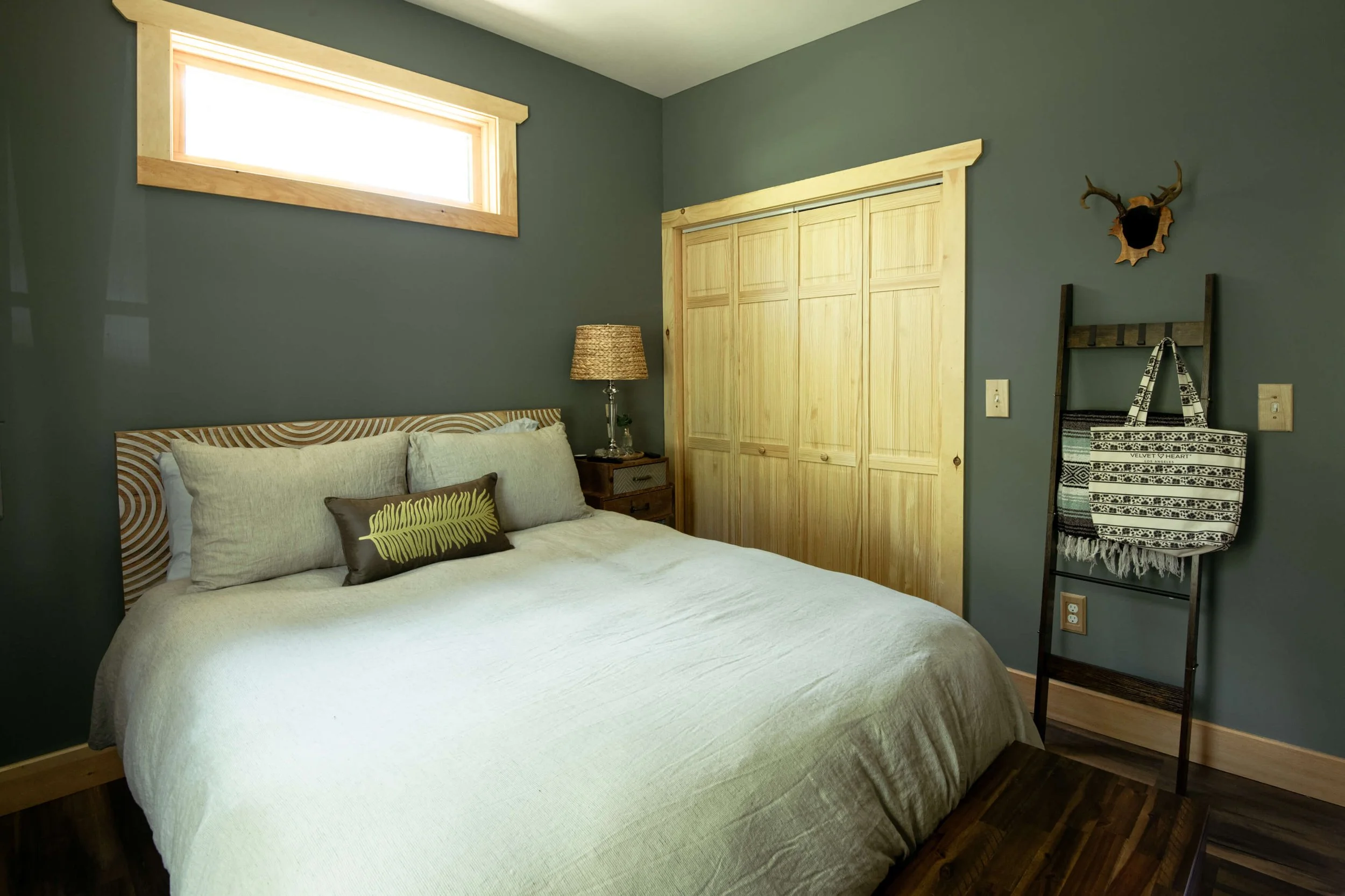 Queen-size-bed-in-room-with-high-window