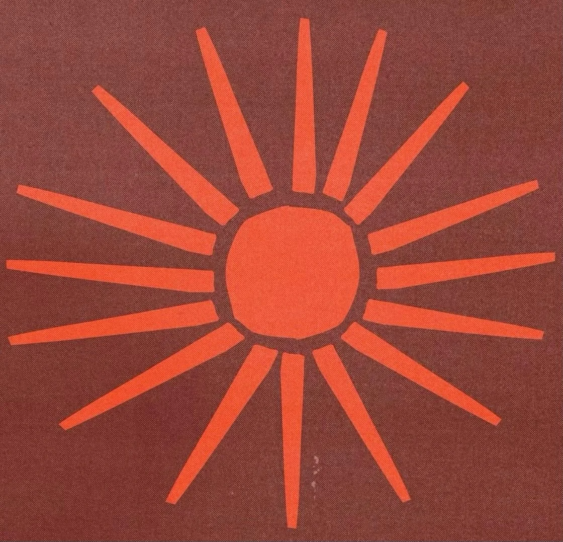A stylized sun with a central circle and elongated rays on a brown background.