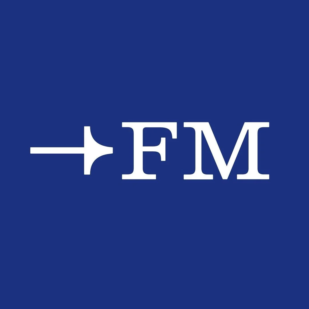 Blue background with white capital letters 'FM' and an airplane symbol pointing to the left.