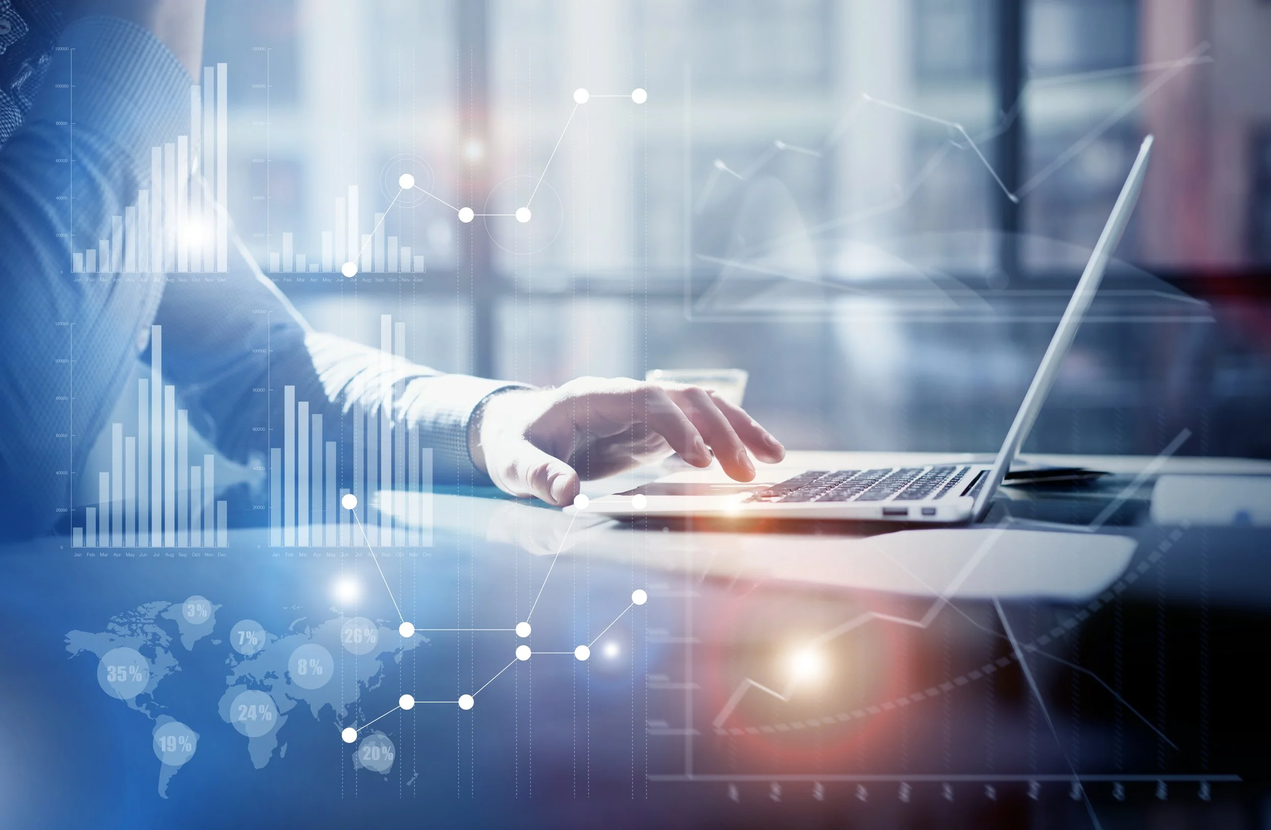 Person using laptop with digital charts, graphs, and world map overlays on screen, suggesting data analysis or financial research.