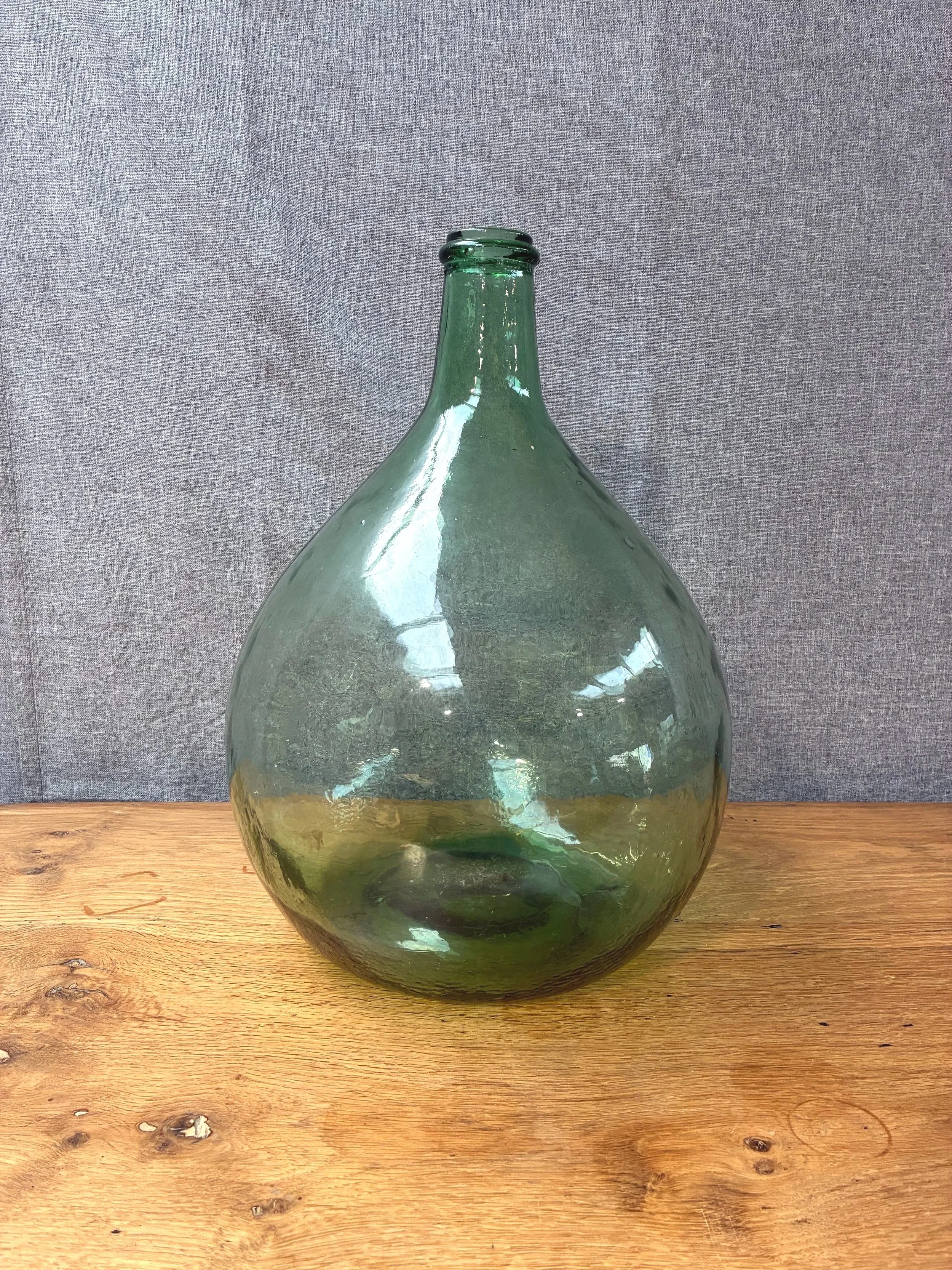 Secondhand vintage glass dame-jeanne carboy