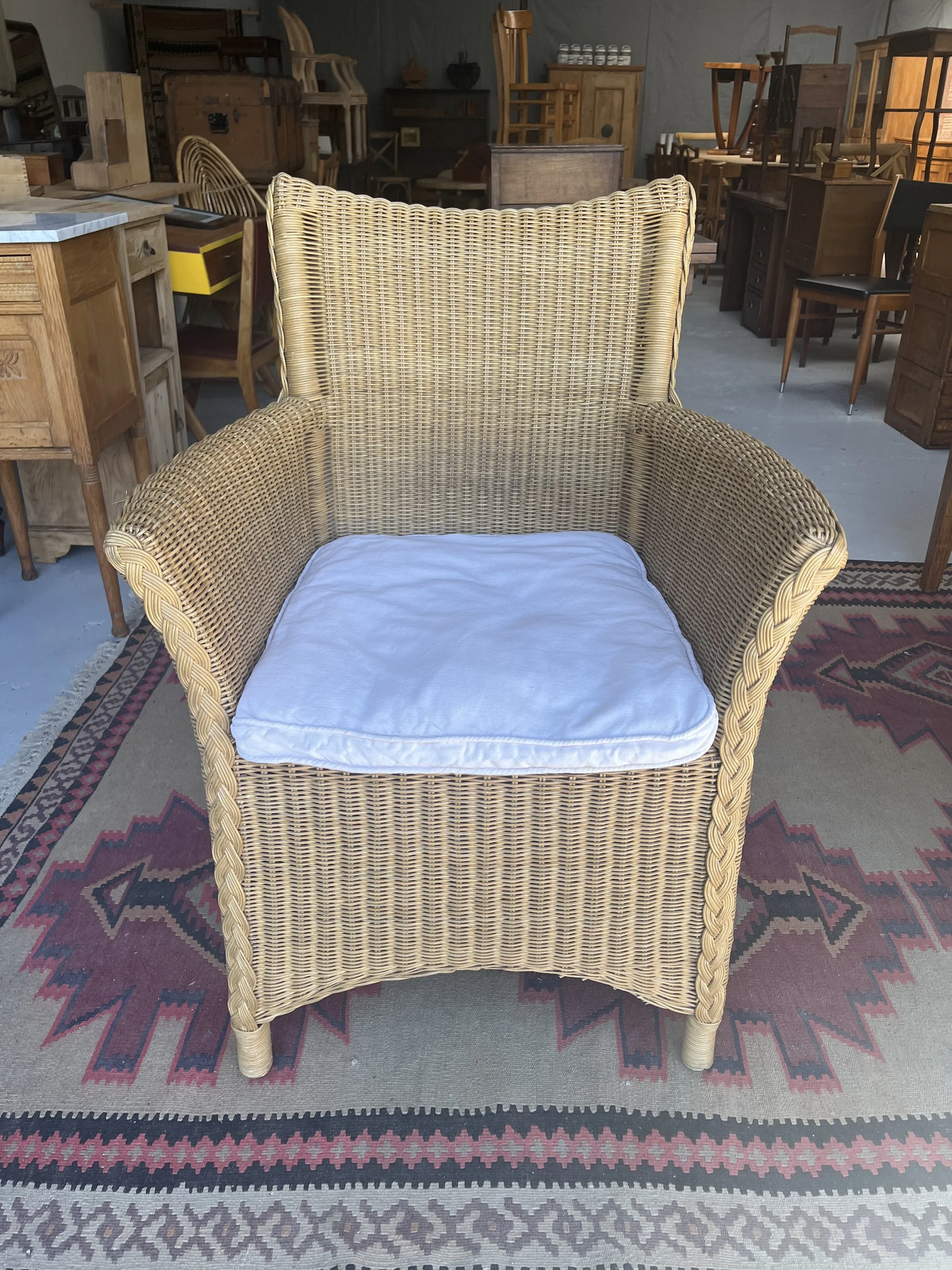 Secondhand vintage wicker armchair