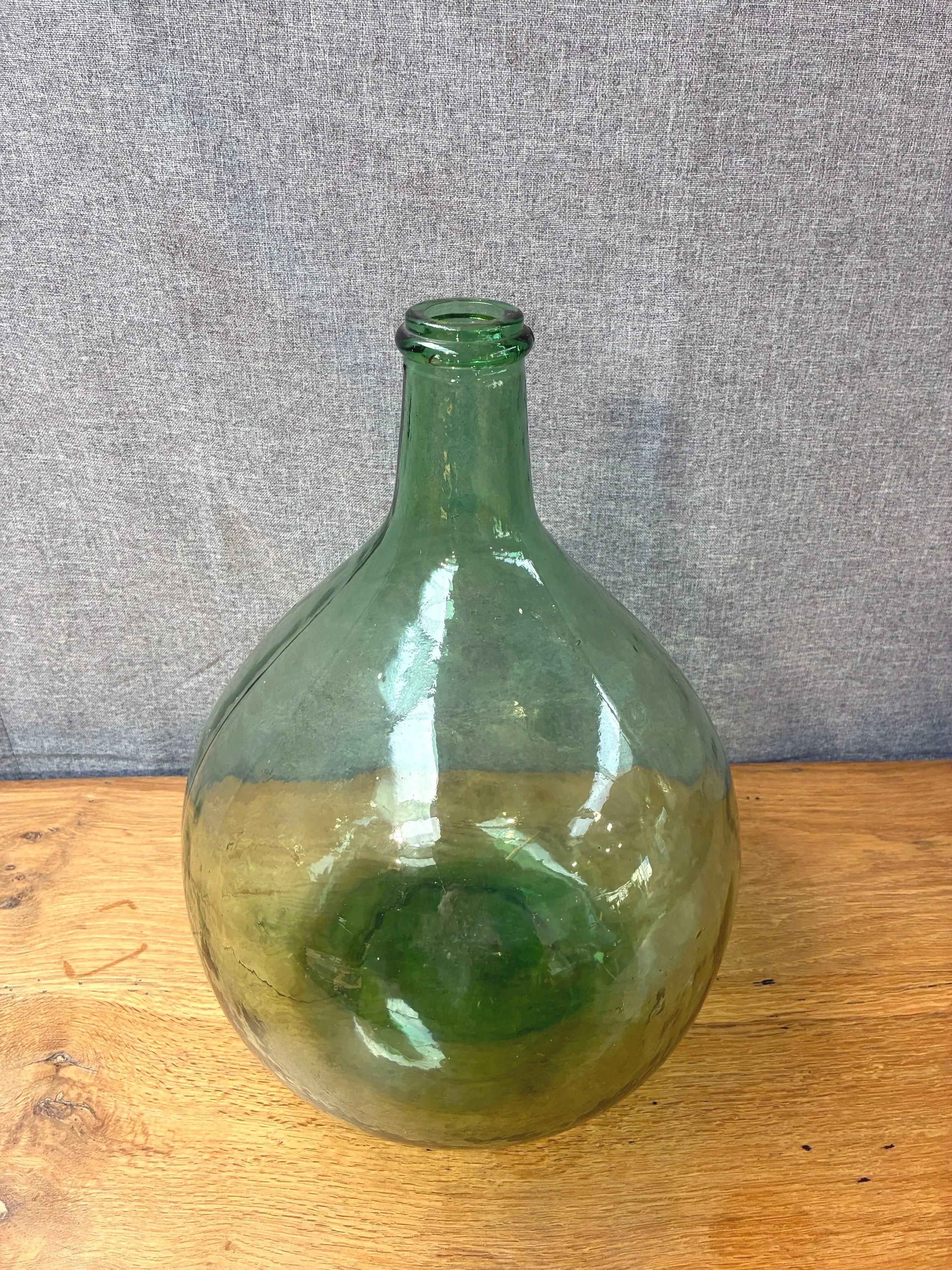 Secondhand vintage glass dame-jeanne carboy