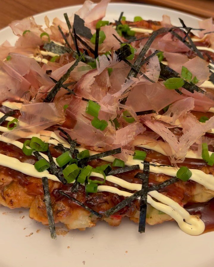 Dancing bonito on Osaka&rsquo;s savory pancake the okonomiyaki and some uni and maguro hand rolls because why not.