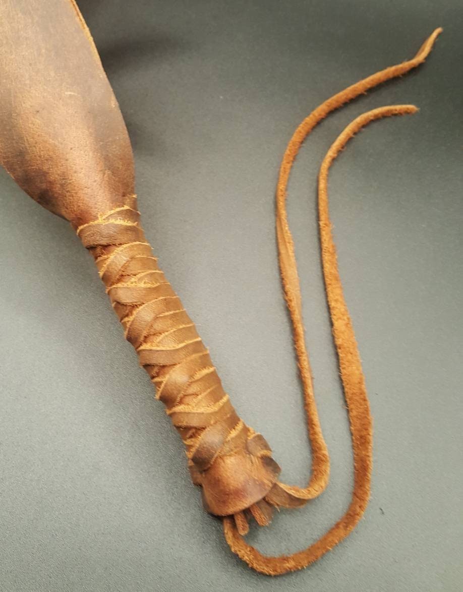 brown and black brown Leather paddle with criss cross leather handle grip