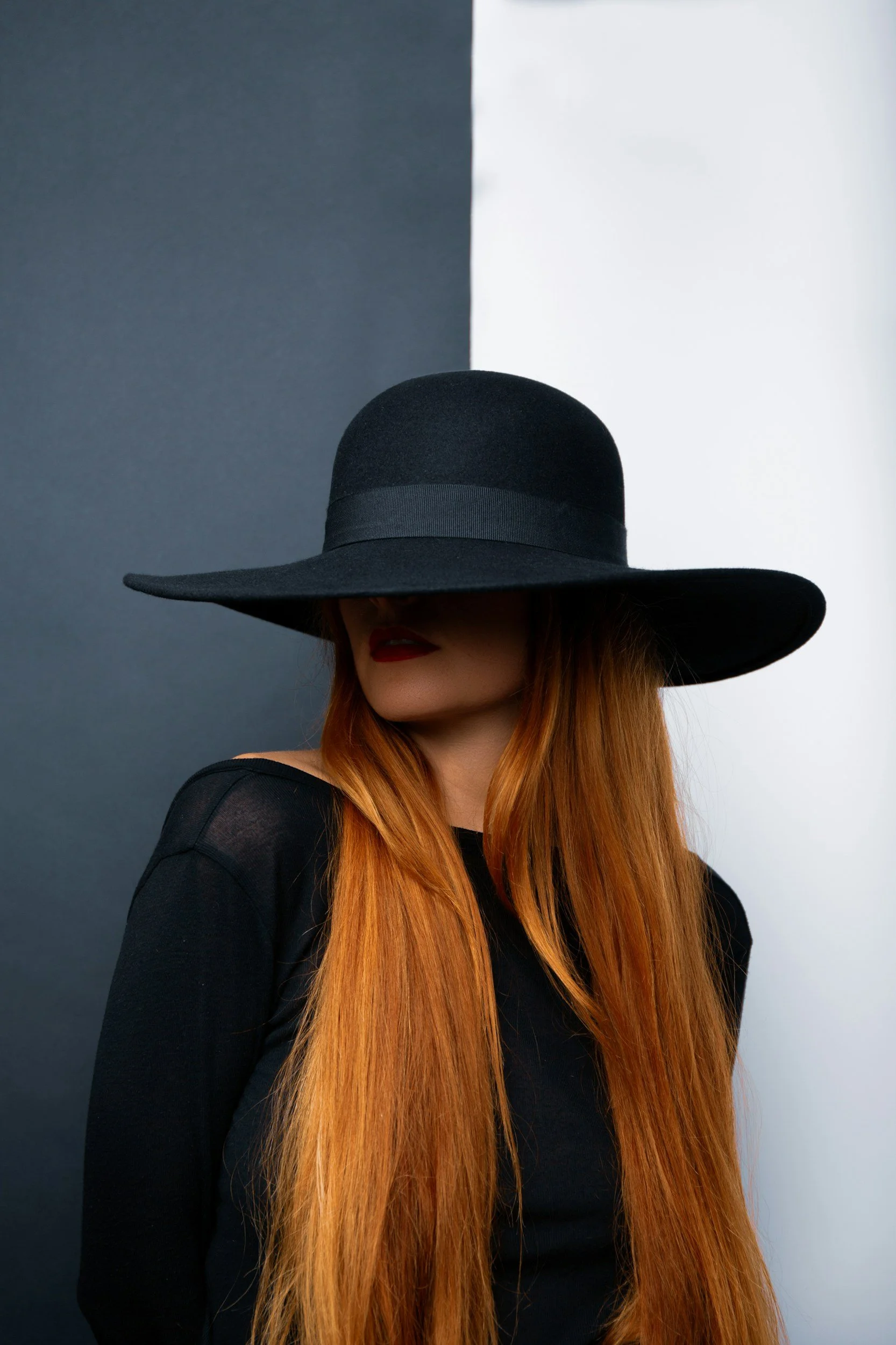 Woman with red hair covering her face, representing emotional distress related to betrayal trauma and infidelity.