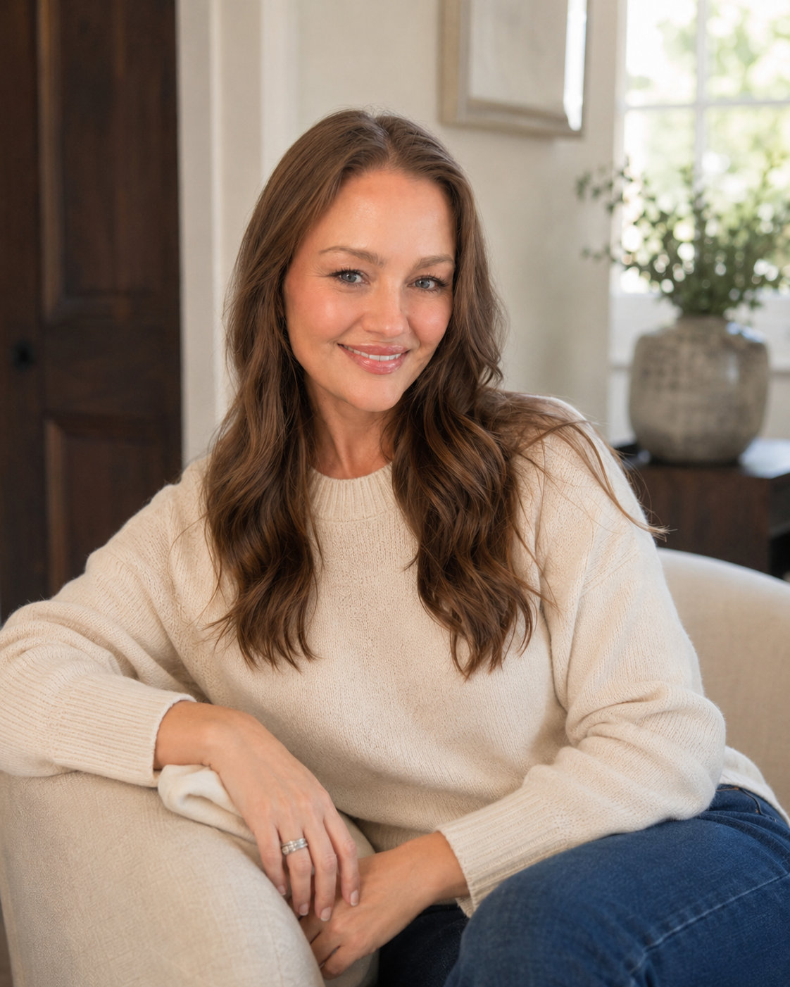 Elizabeth Boyer, LMFT, Somatic Therapist &  Yoga Teaher seated in therapy office.