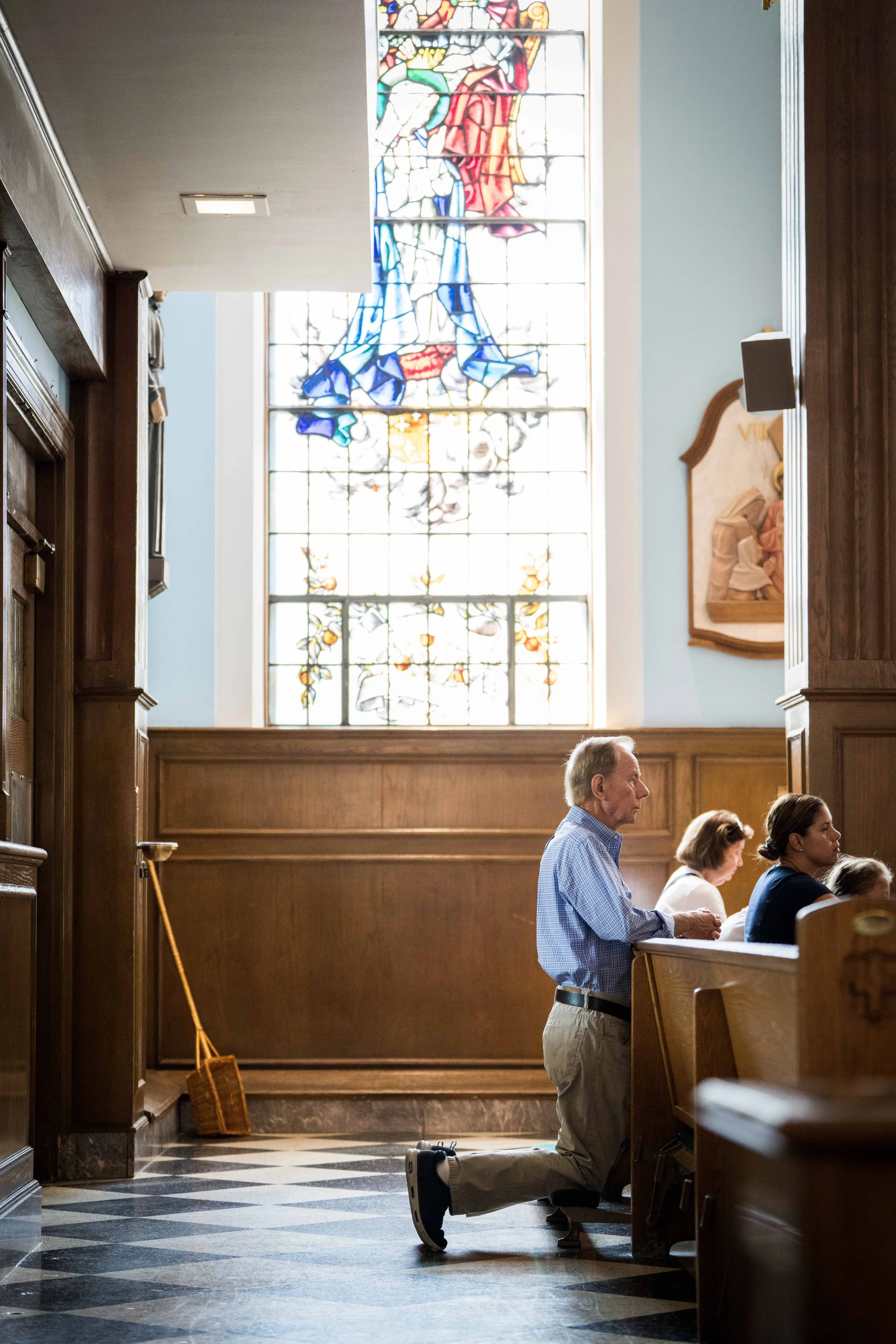 A parishioner prays during Sunday Mass at the Church of St. Aidan in Williston Park, NY