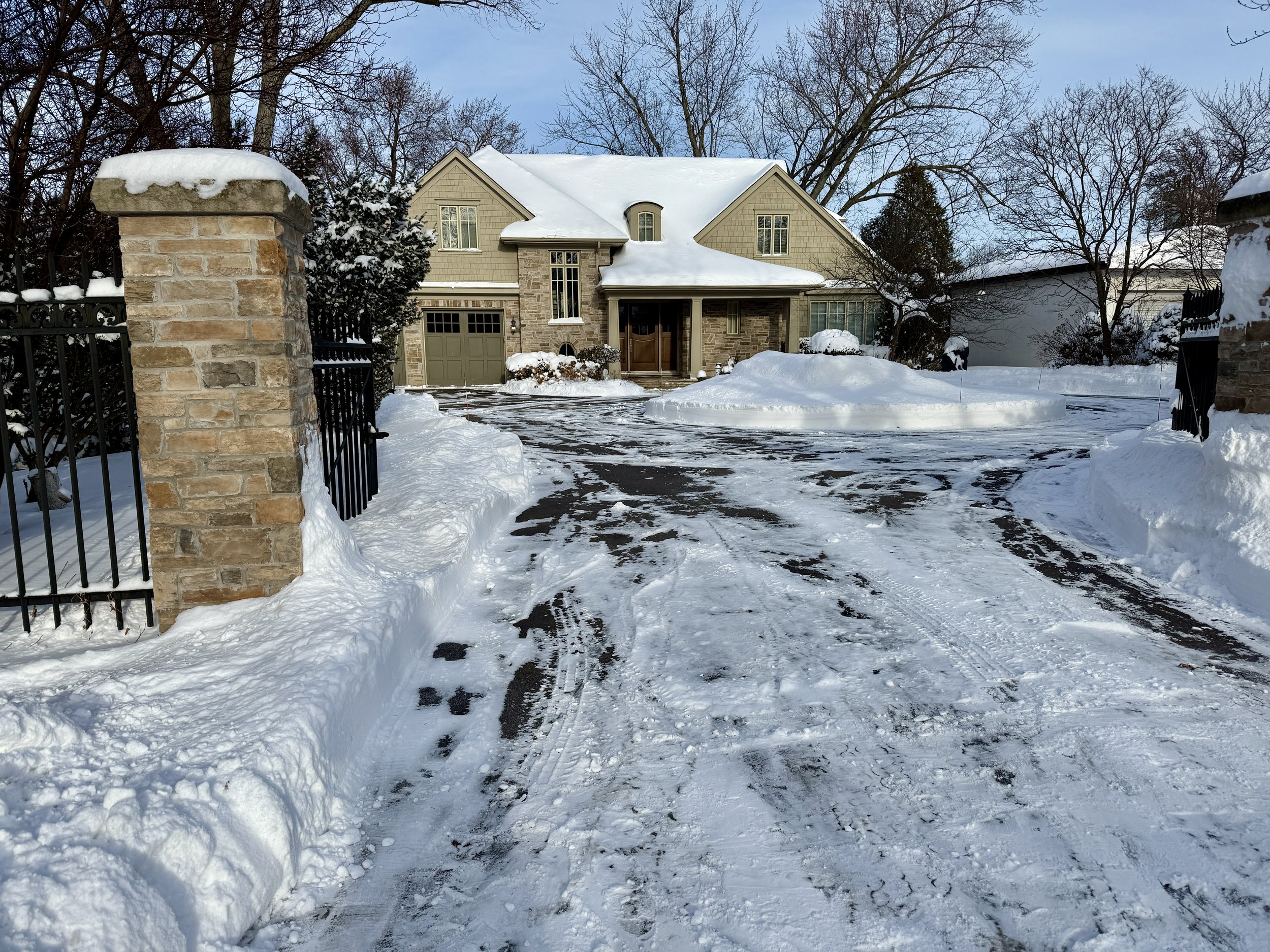 Residential snow removal service at a South Oakville home during winter