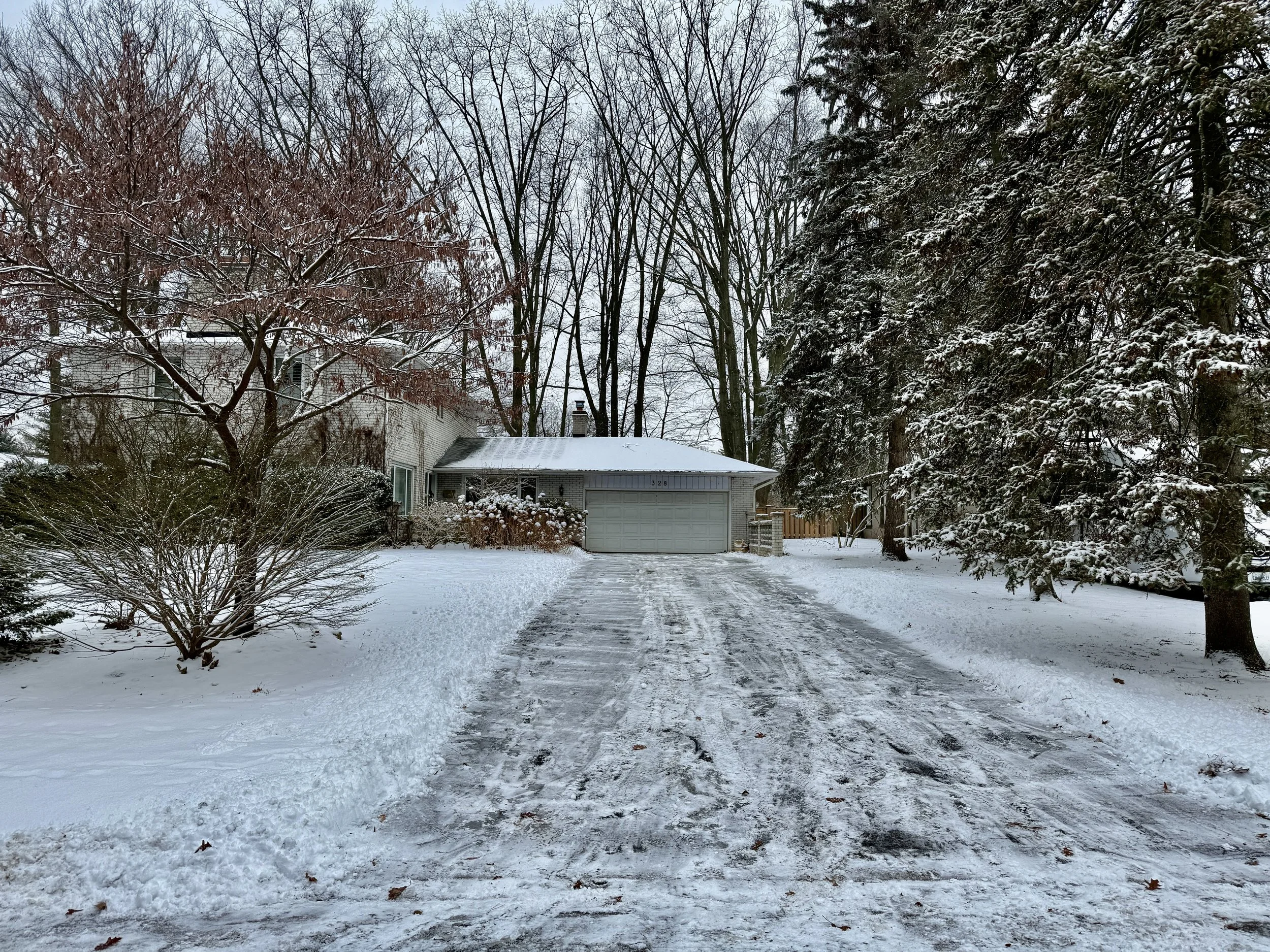 Residential snow removal service at a South East Oakville home during winter