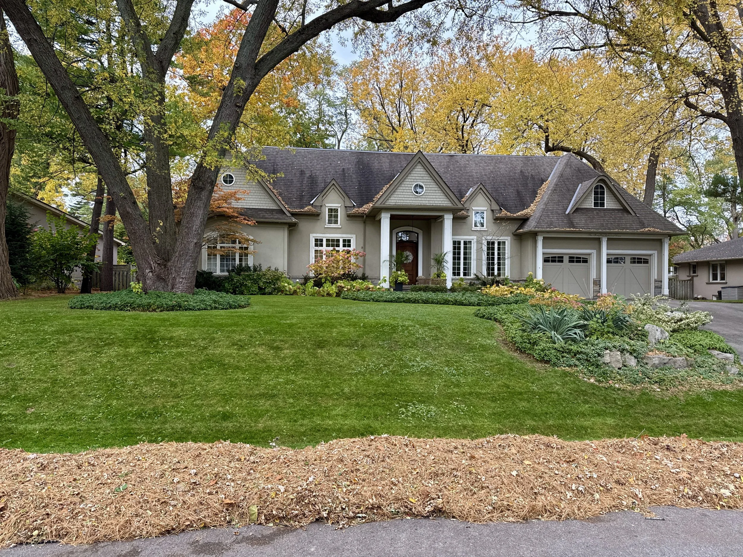Fall Clean-up in the Lakeshore Area in Oakville, ON. Leaves blown to curb for town leaf collection. 