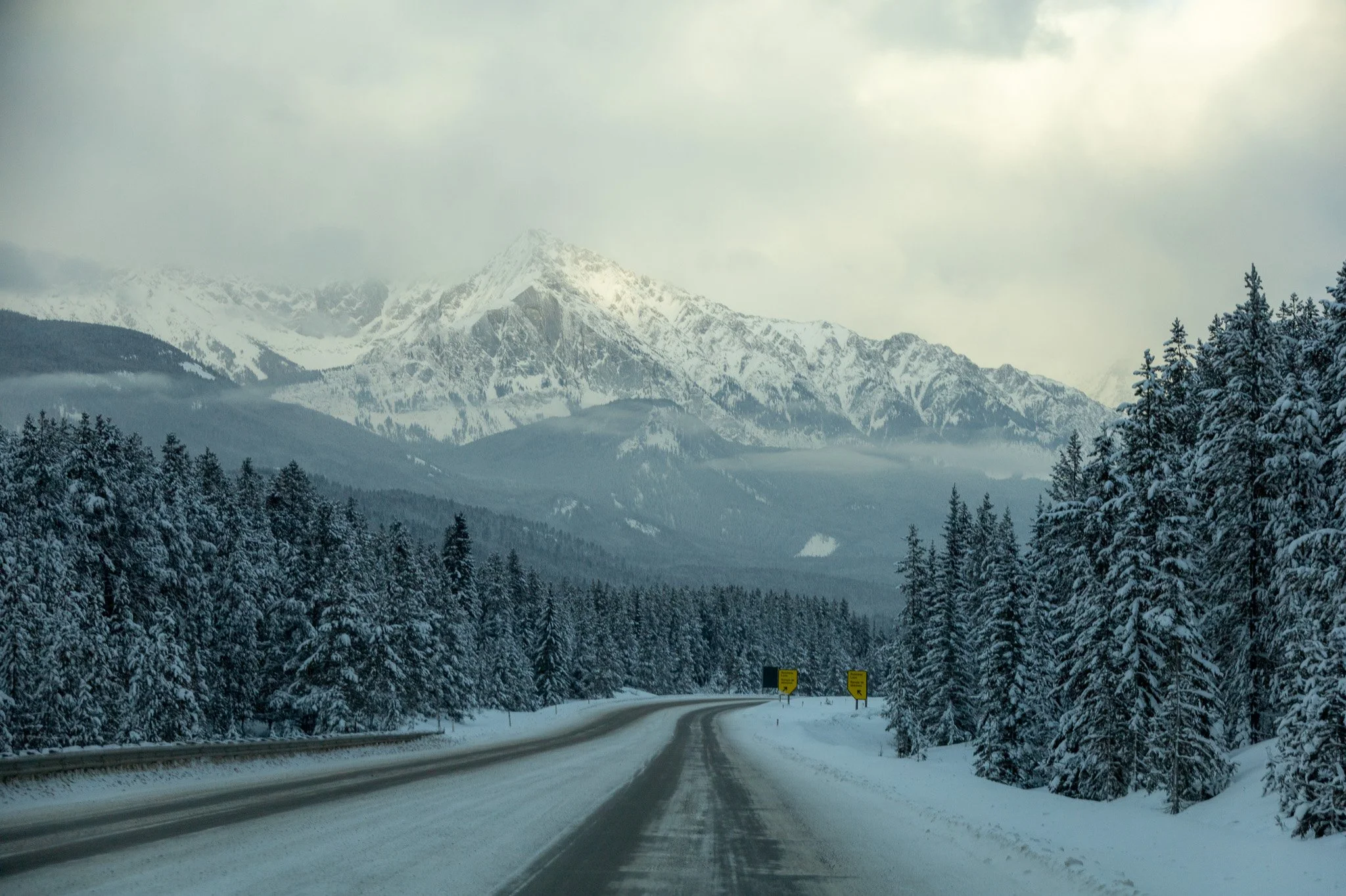 Road and snowy mountains in Banff National Park.jpg