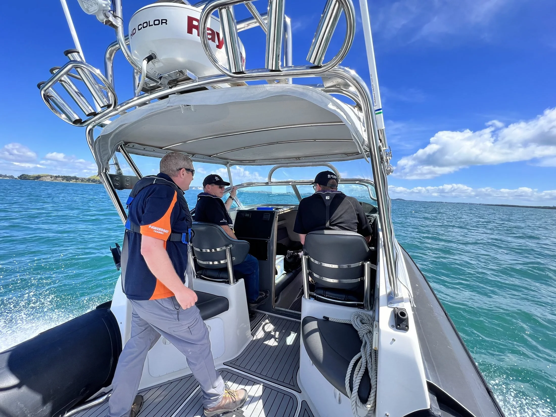 RYA Powerboat Level 2 students at the helm during on-water training in the Hauraki Gulf, Auckland