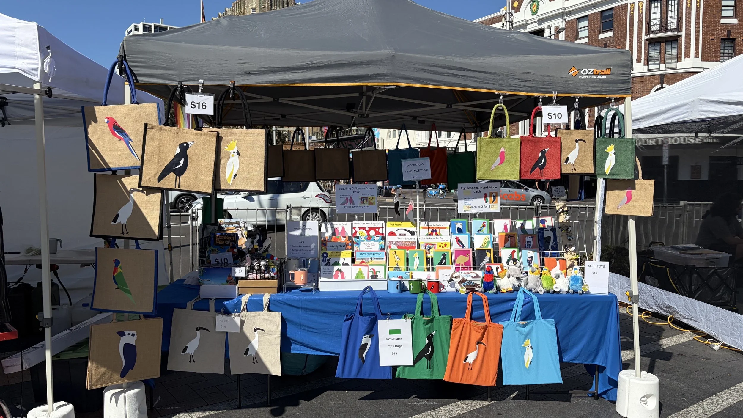 Markey stall to purchase tote bags, keep cups, cards, and books