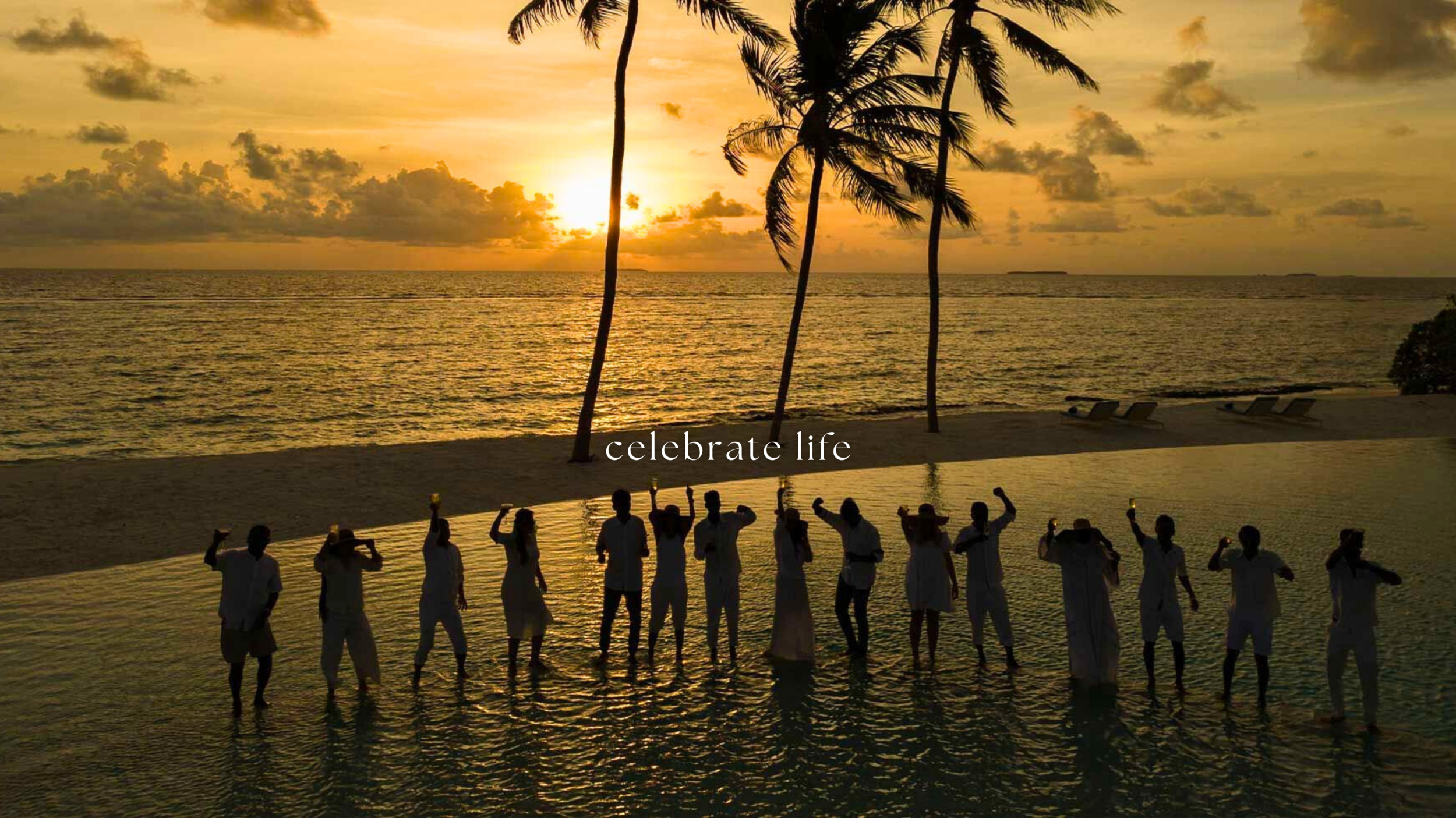 Silhouettes of people celebrating on a beach at sunset, holding candles, with palm trees and a calm ocean in the background, and the words 'celebrate life' overlaid.