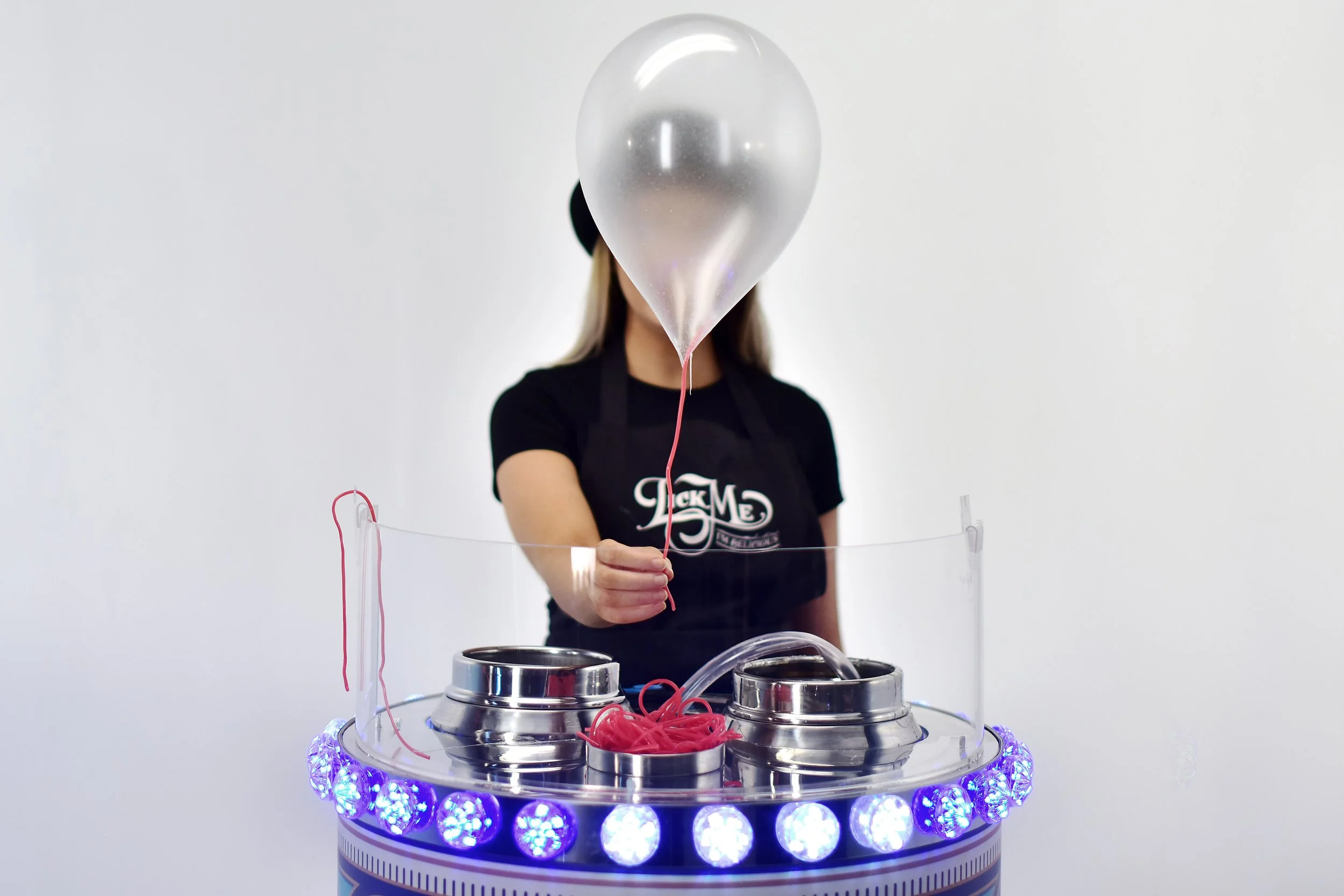 An image of a lady holding an edible balloon