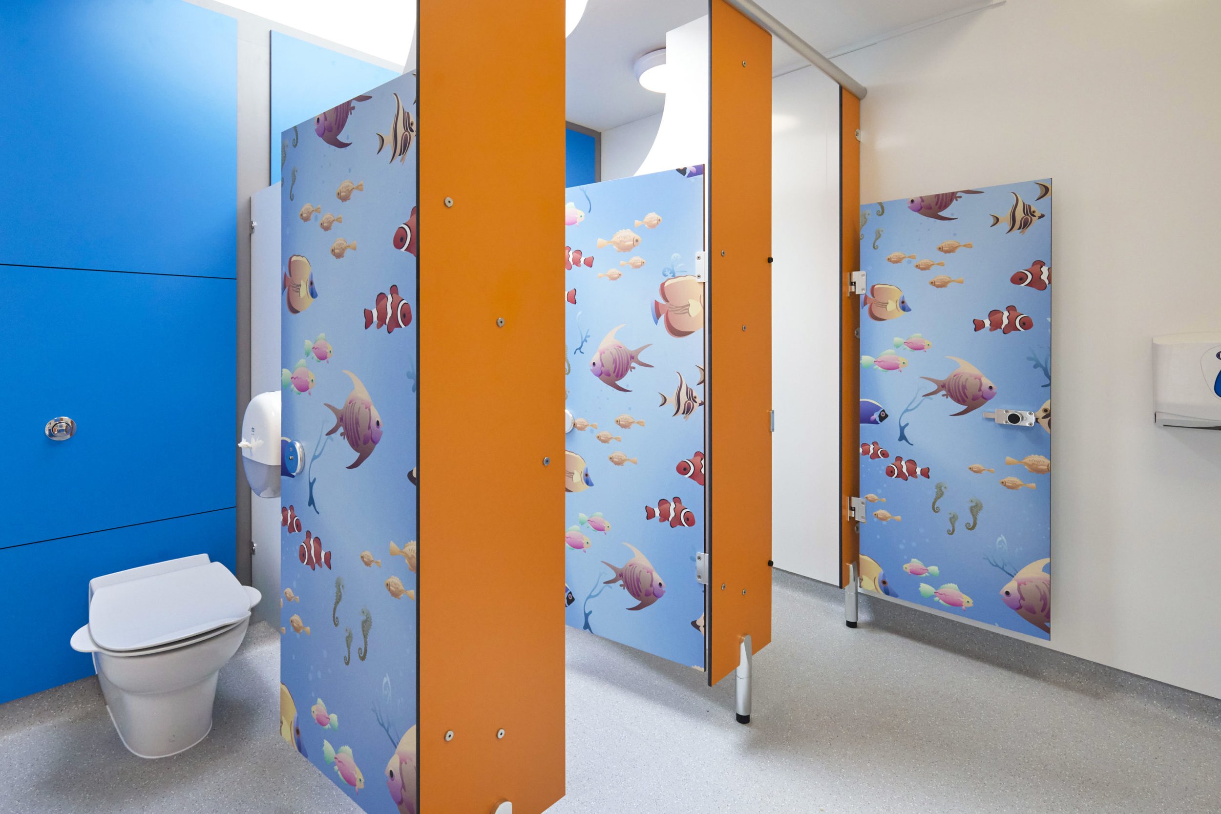 junior cubicles with blue duct panels, orange divisions and waterworld print doors at upland school.jpg
