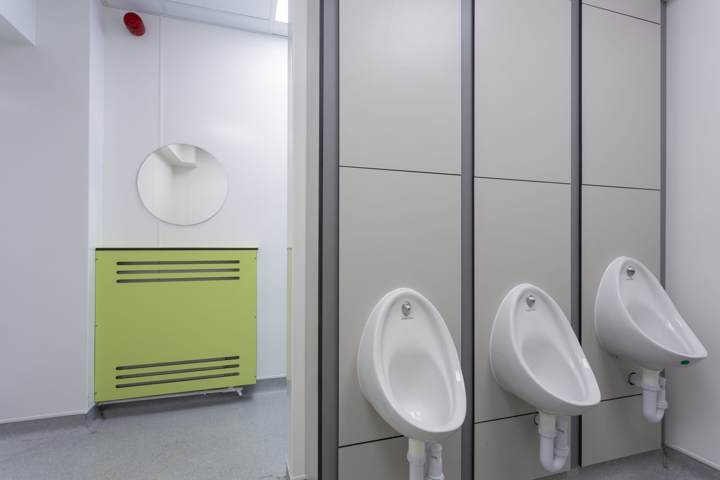 urinals with grey duct panels and a green radiator cover at cliff park school.jpg