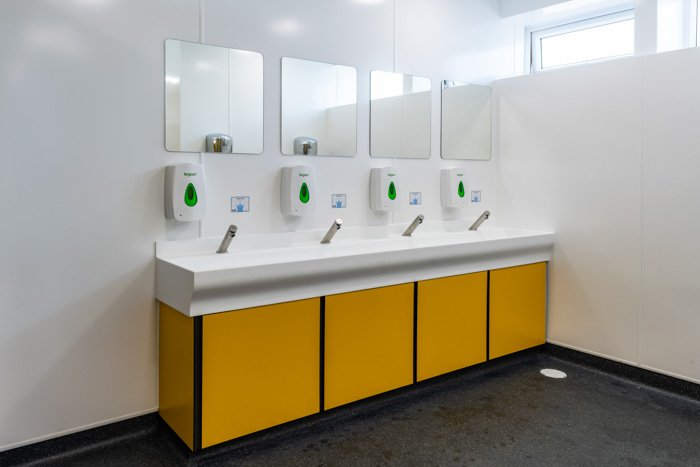 vanity unit hand wash area with trough top and touch-free taps at southwold toilets 2.jpg