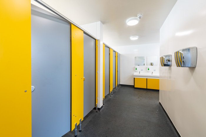 female washroom with grey and yellow cubicles, hygienic cladding & hand dryers southwold.jpg