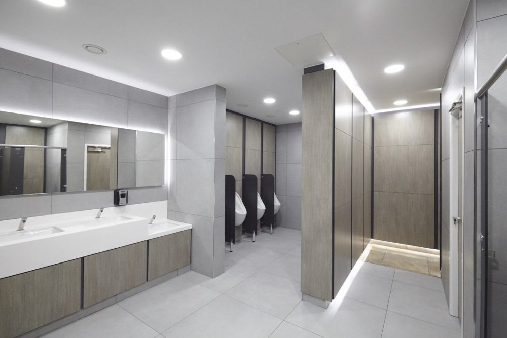 entrance into toilets at shopping centre, urinals, ducts, vanity with corian top.jpg