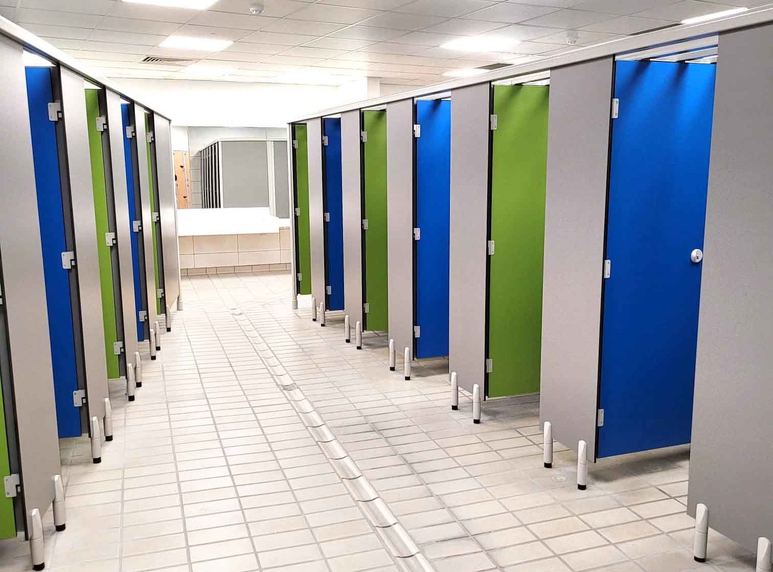 row of blue and green changing cubicles in a changing room at herons leisure centre.jpg