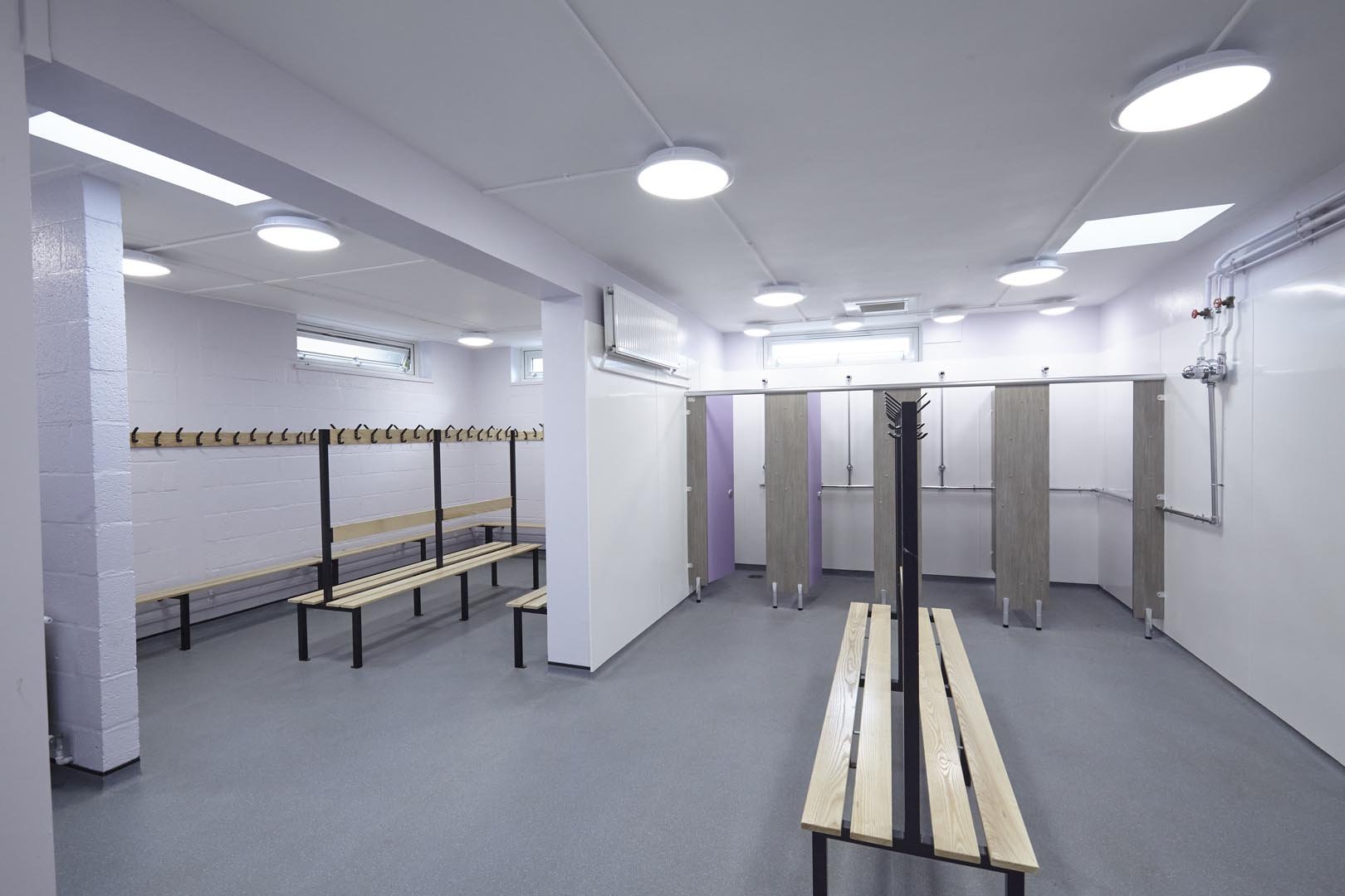 changing room with shower cubicles and benching at churchmead school.jpg